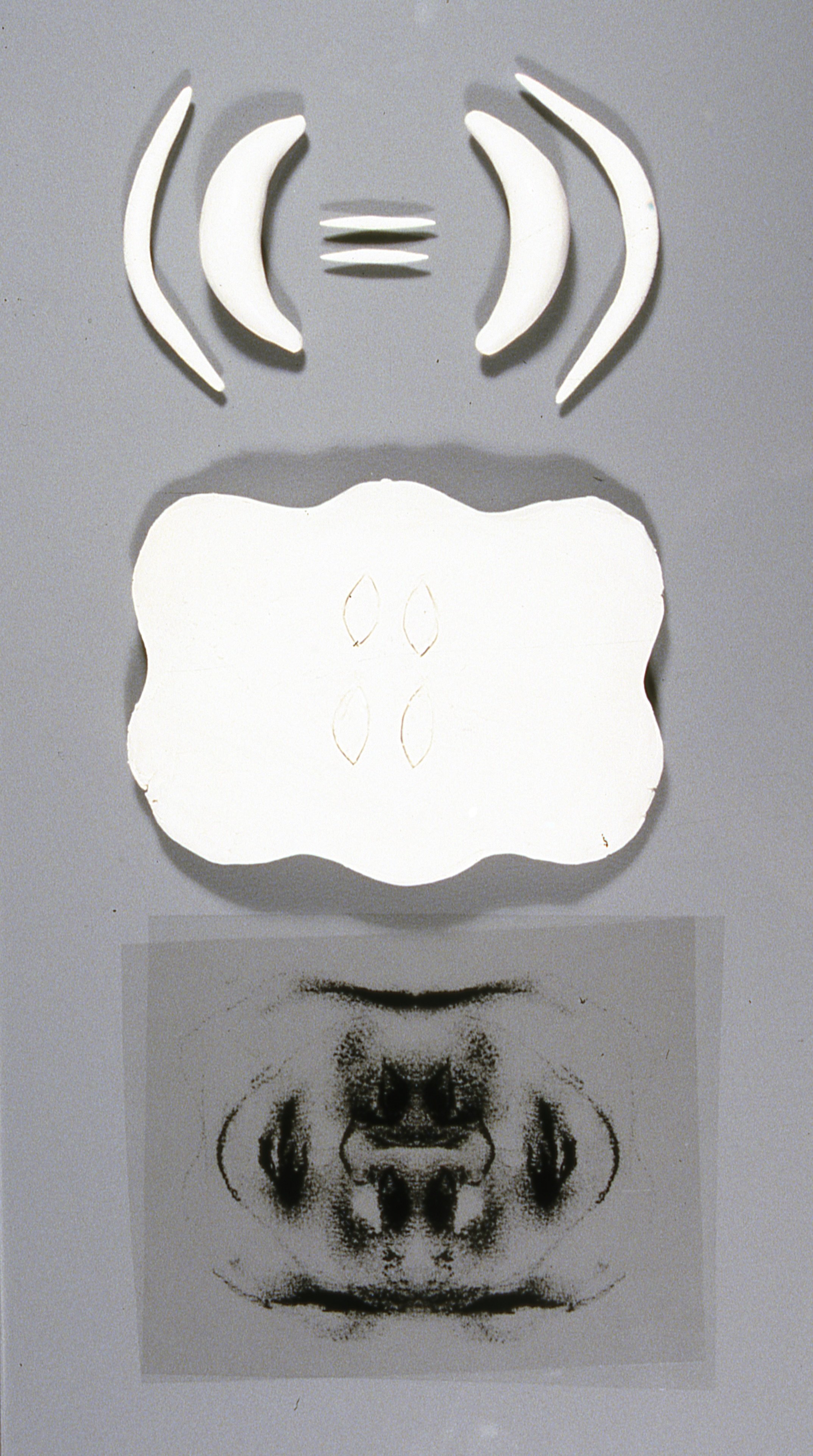 Sculpture With Faces and 3-D Tablet and Equation Forms, KBDesrosiers, 12%22x20%22x2%22, transparencies of charcoal drawings under smoked glass and fired clay forms.jpeg