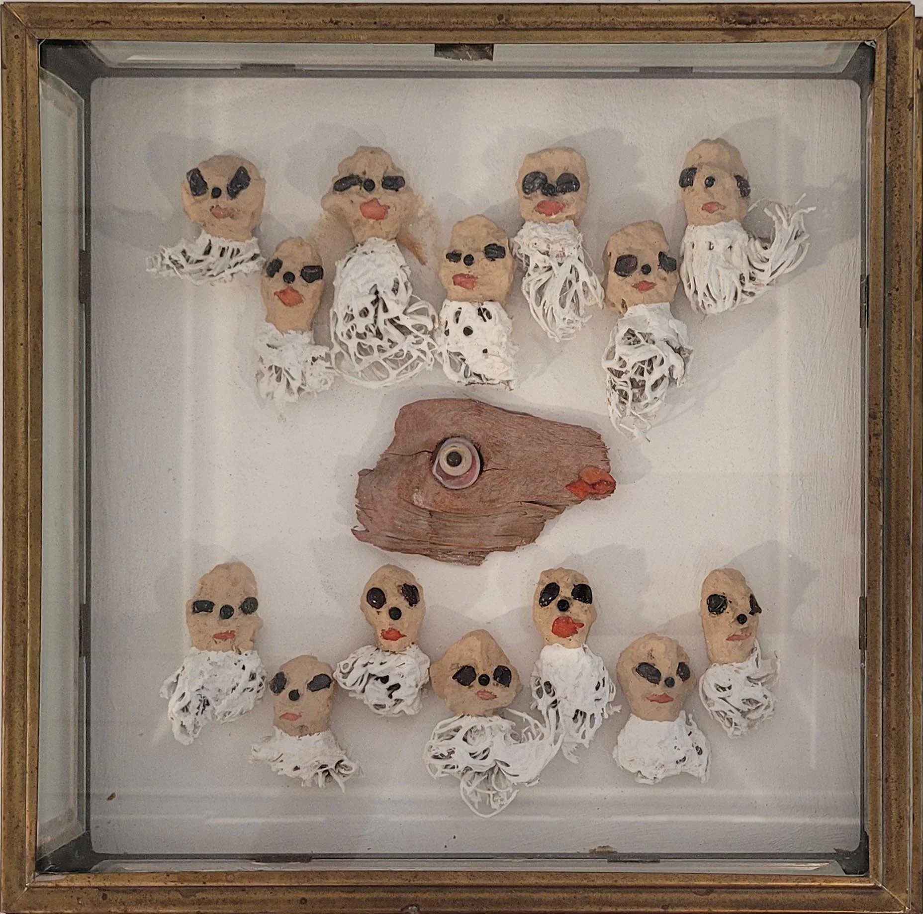 Food for Thought , 2013, 11" x 11",
dried apple heads, onion roots, garnet eyes, brass glass case, $1950