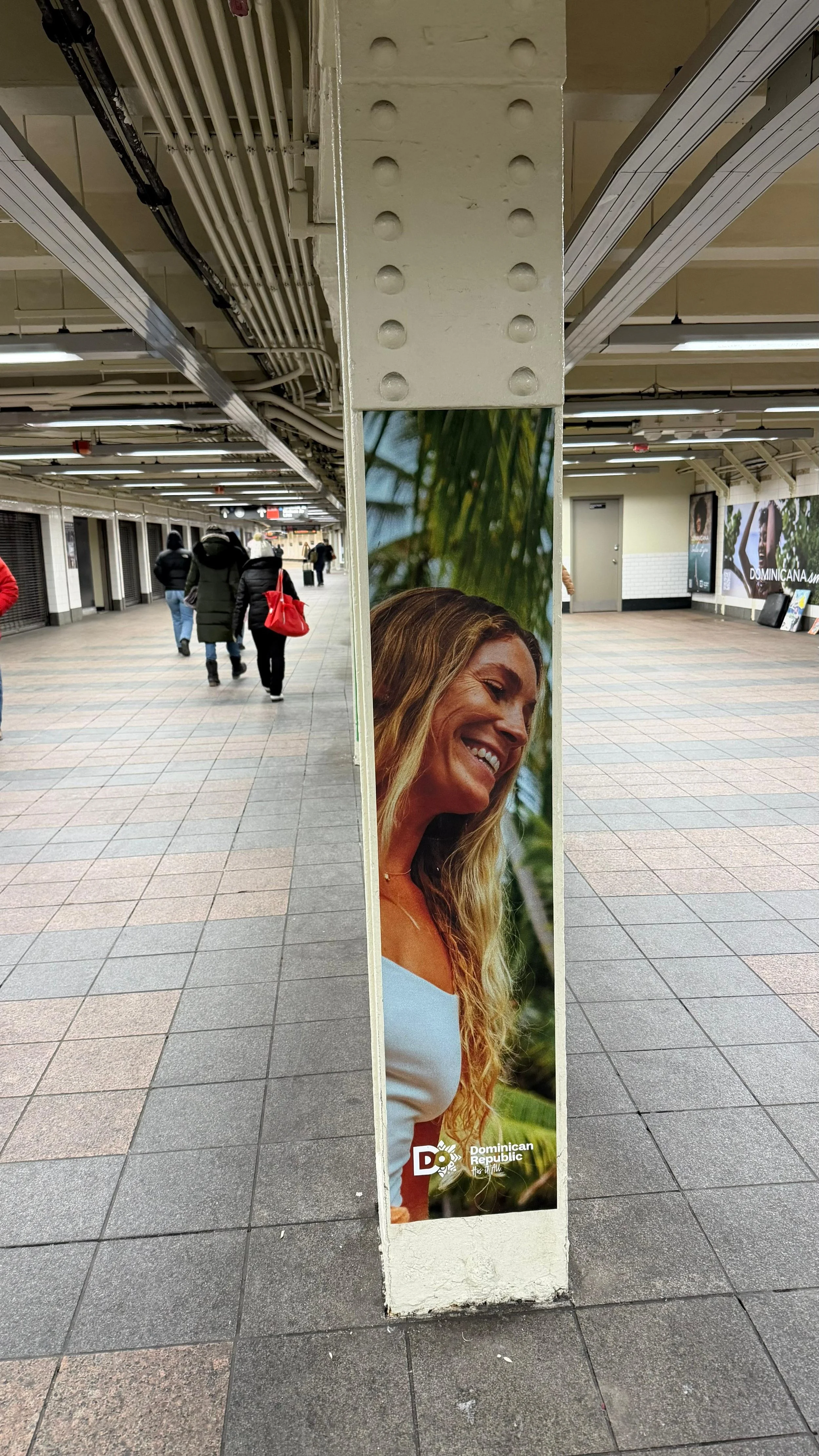 New York City subway billboard tourism campaign featuring model Megan Koval at 42nd Street Grand Central Station.
