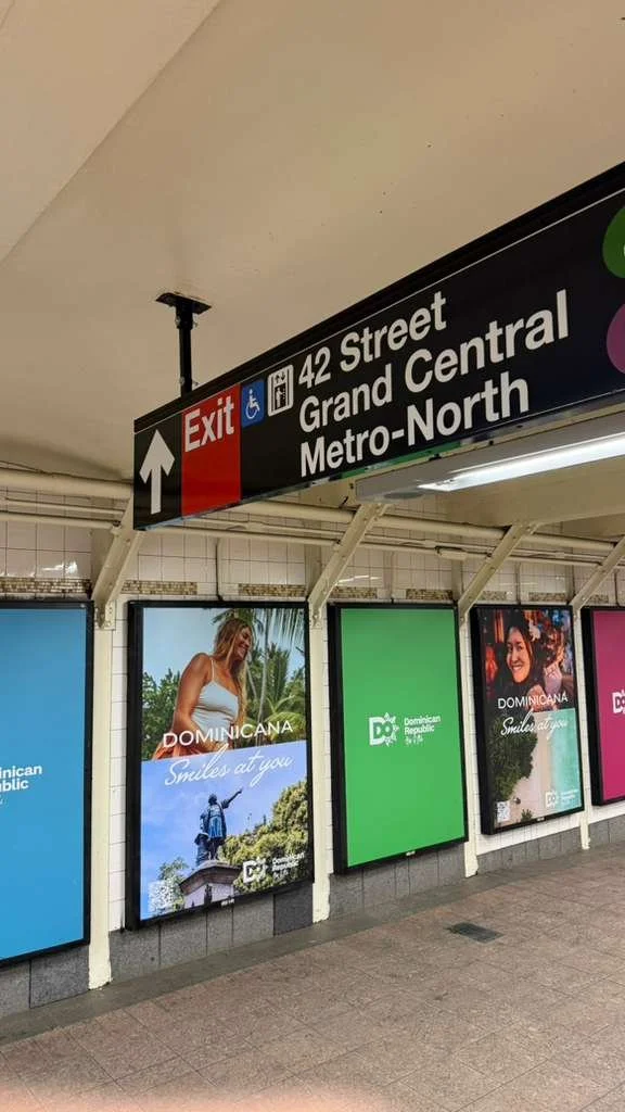 Tourism campaign billboard of Megan Koval displayed at the Metro-North 42nd Street exit in Grand Central Station.