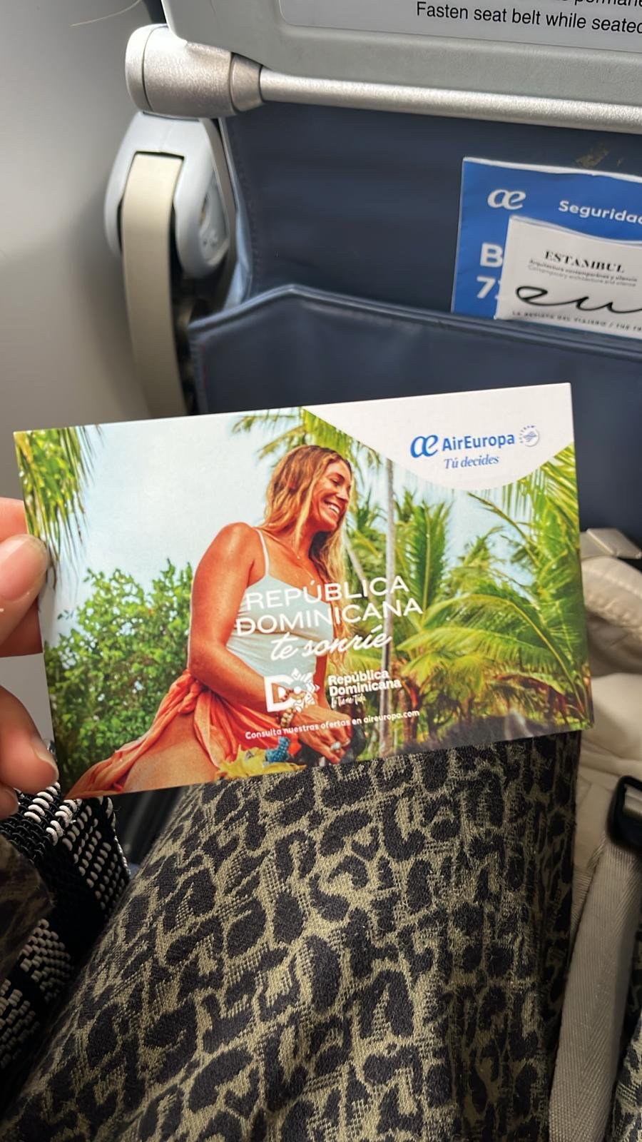 International tourism campaign featuring Megan Koval displayed on Air Europa airplane seats.