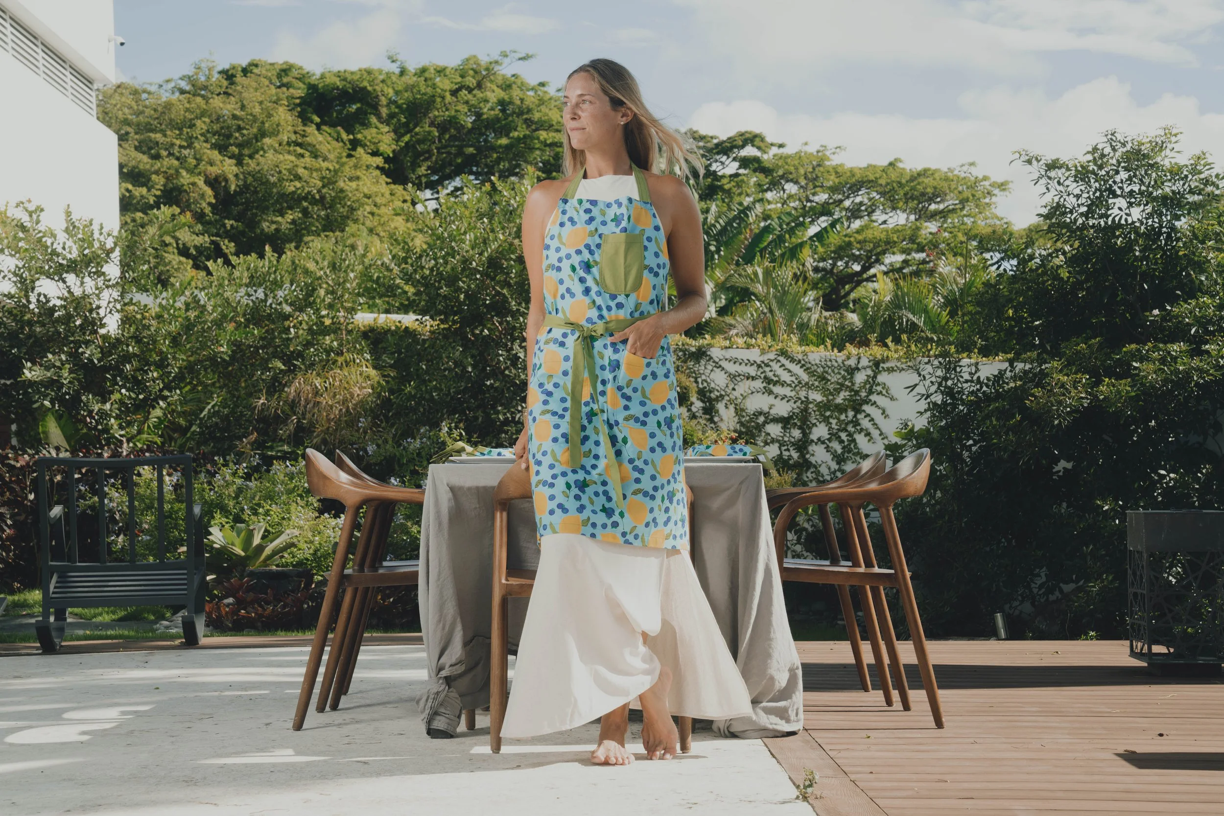 Lifestyle model preparing table in a luxury Caribbean villa kitchen, capturing relaxed coastal living and resort lifestyle imagery.