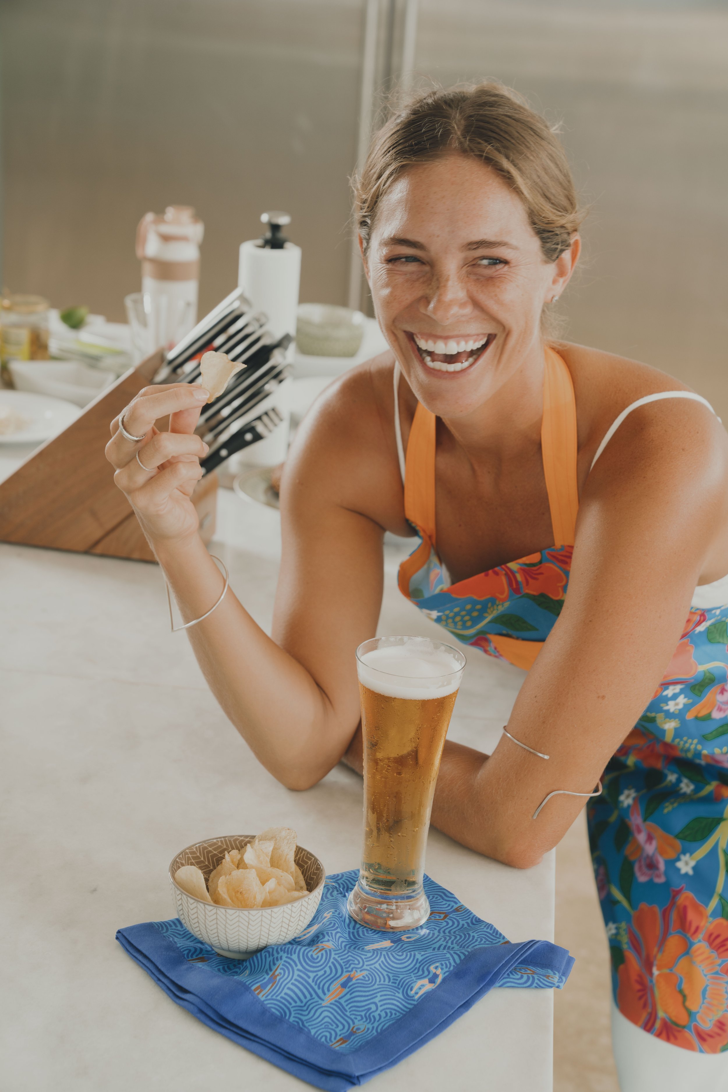 Lifestyle model preparing food and enjoying hosting in a luxury Caribbean villa kitchen, capturing relaxed coastal living and resort lifestyle imagery.