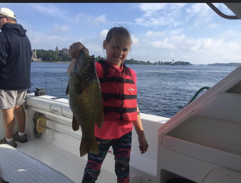 thousand island footer charter little girl holding caught fish