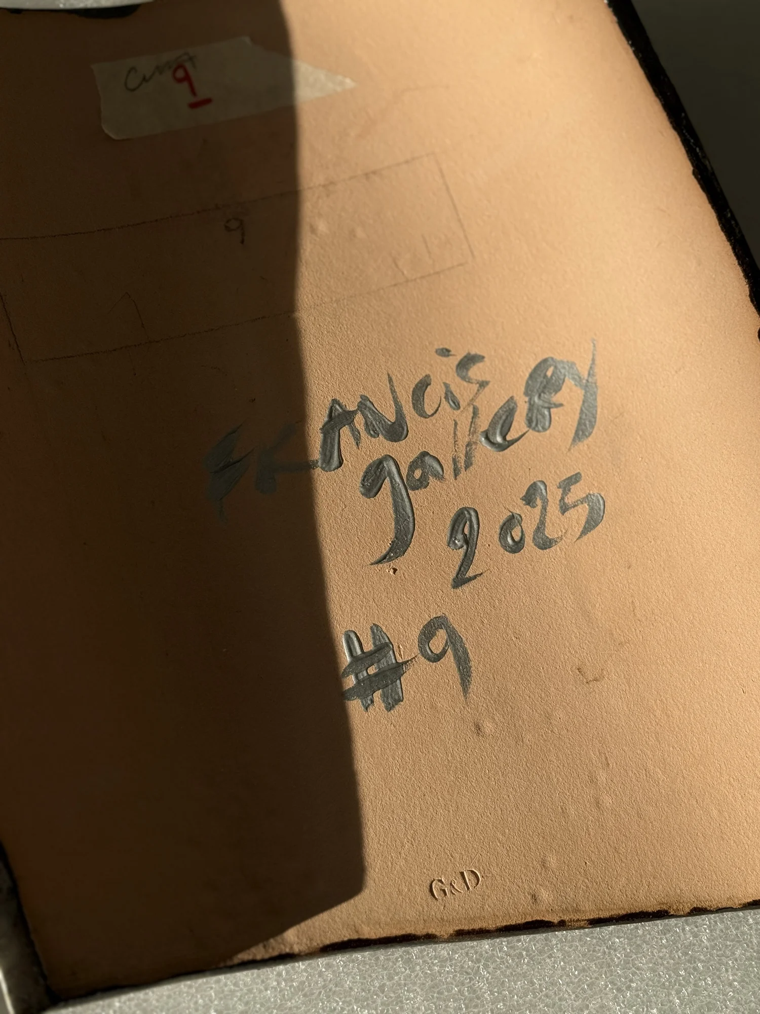 The underside of a piece, signed and numbered by hand