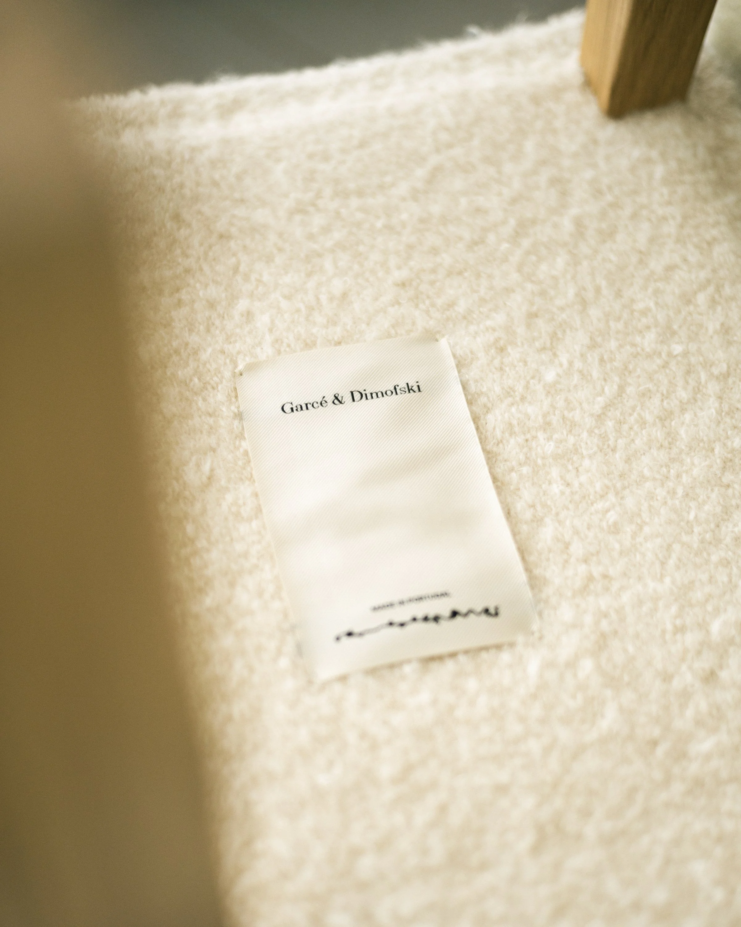 The signed Garcé Dimofski label on a bouclé seat