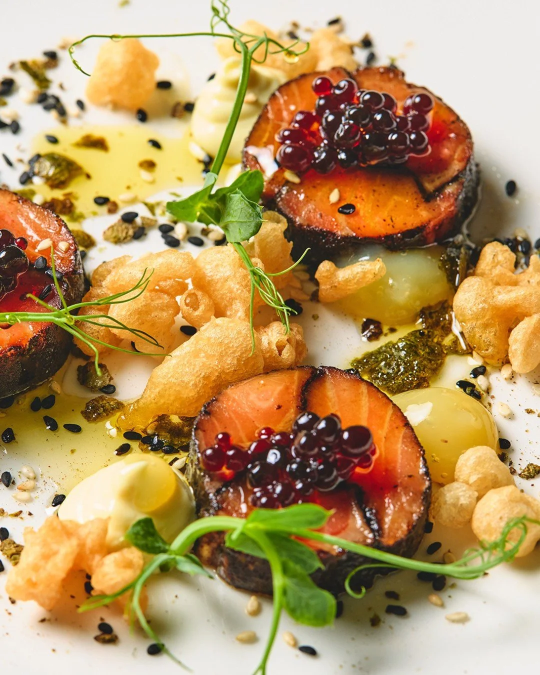 Start dinner right: Chilled Salmon Mosaic with allium ash, soy sauce pearls, tempura crumb, lemon gel, wasabi aioli, &amp; furikake.

📸 @briansamuelsphotography