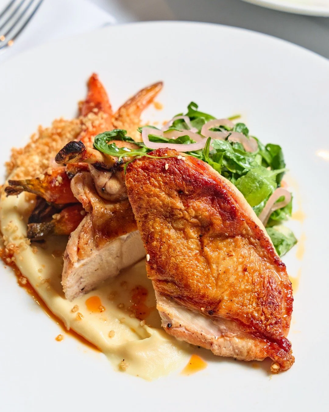 Join us for dinner: roasted chicken with roasted baby carrots, aleppo chili oil, crispy quinoa, parsnip pur&eacute;e, and pickled shallot.

📸 @briansamuelsphotography