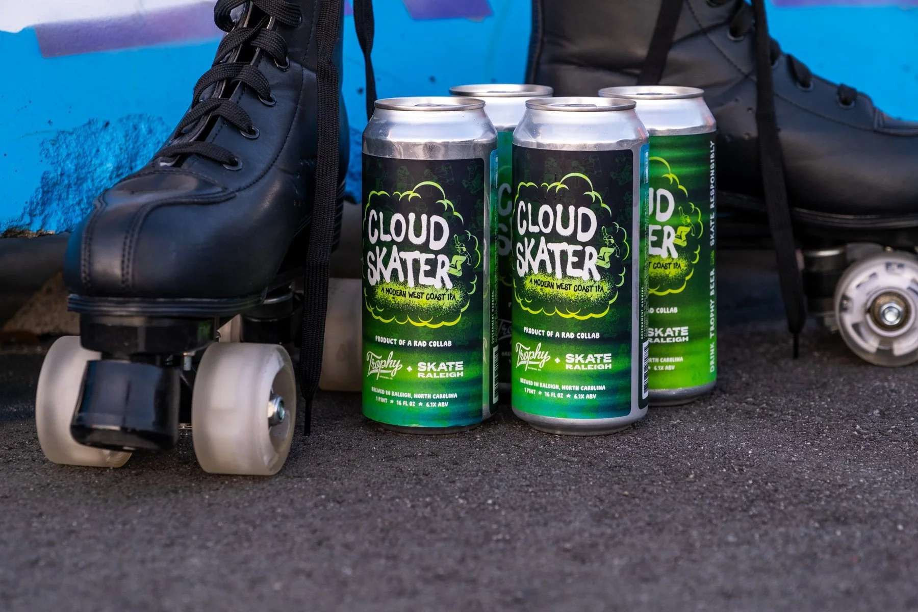 A photo of roller skates next to cans of Cloud Skater.
