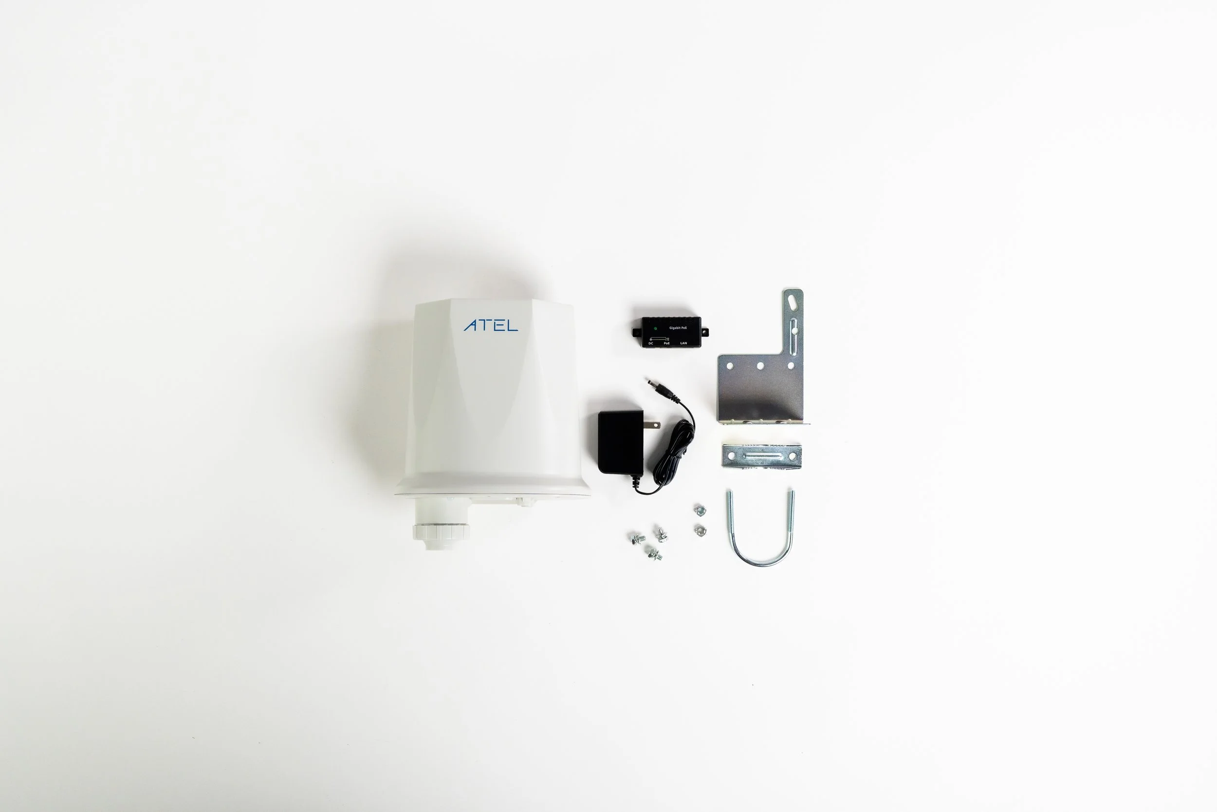 Collection of hardware components including a white ATEL device, black power supply, metal brackets, U-shaped bolt, and screws, arranged on a white background.