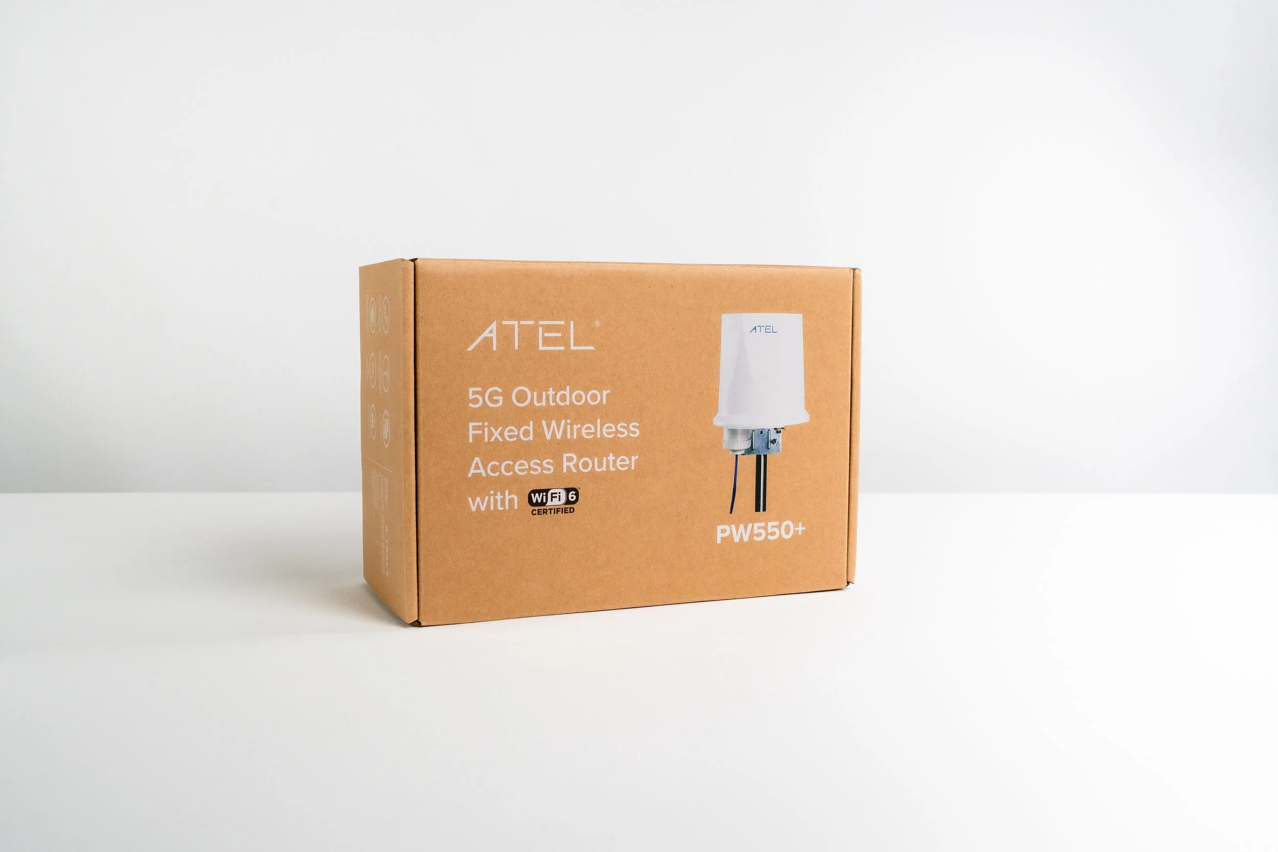 A cardboard box of ATEL 5G outdoor fixed wireless access router model PW550+ on a white surface with a plain white background.