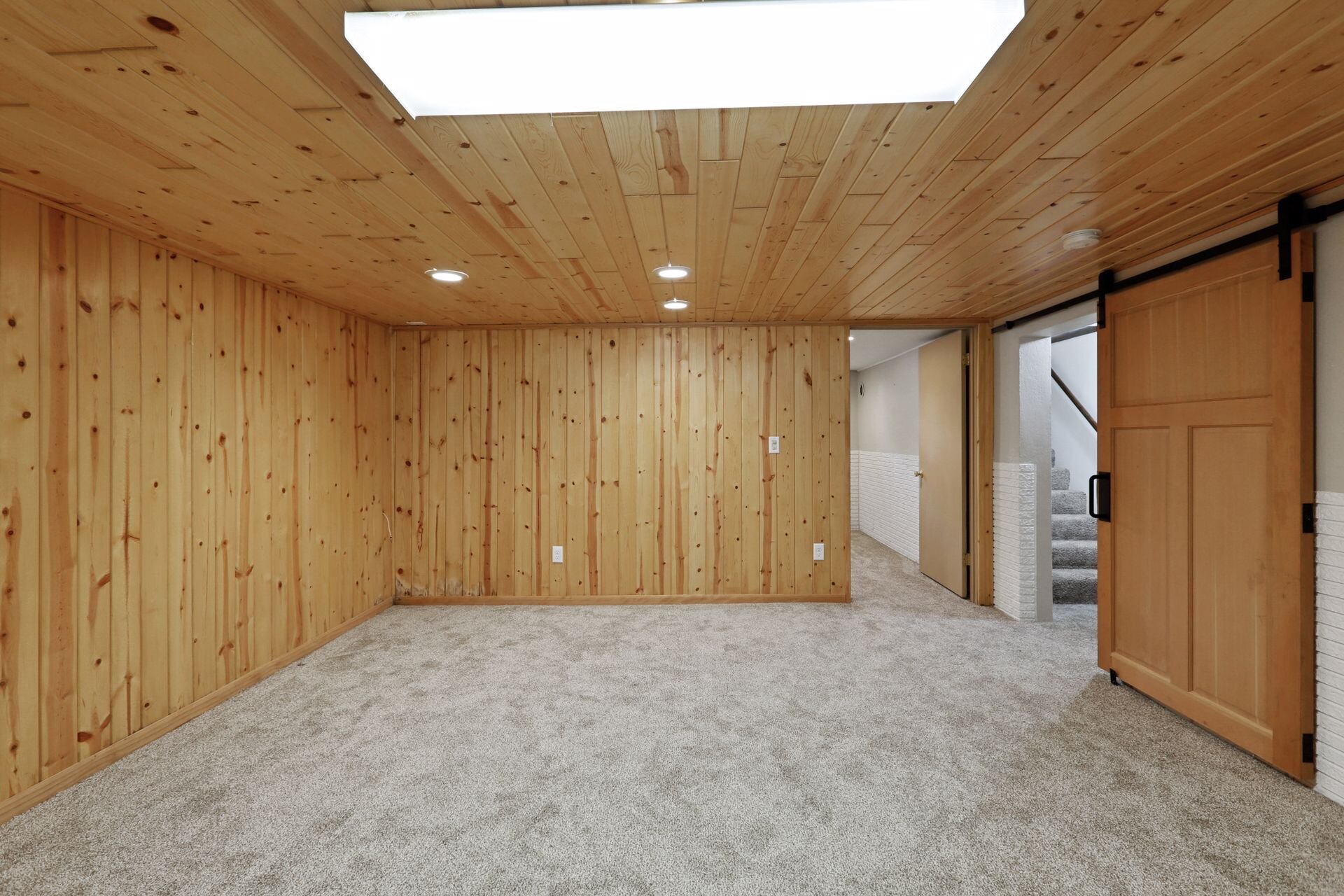 15. Gorgeous natural wood paneling throughout lower level.jpg