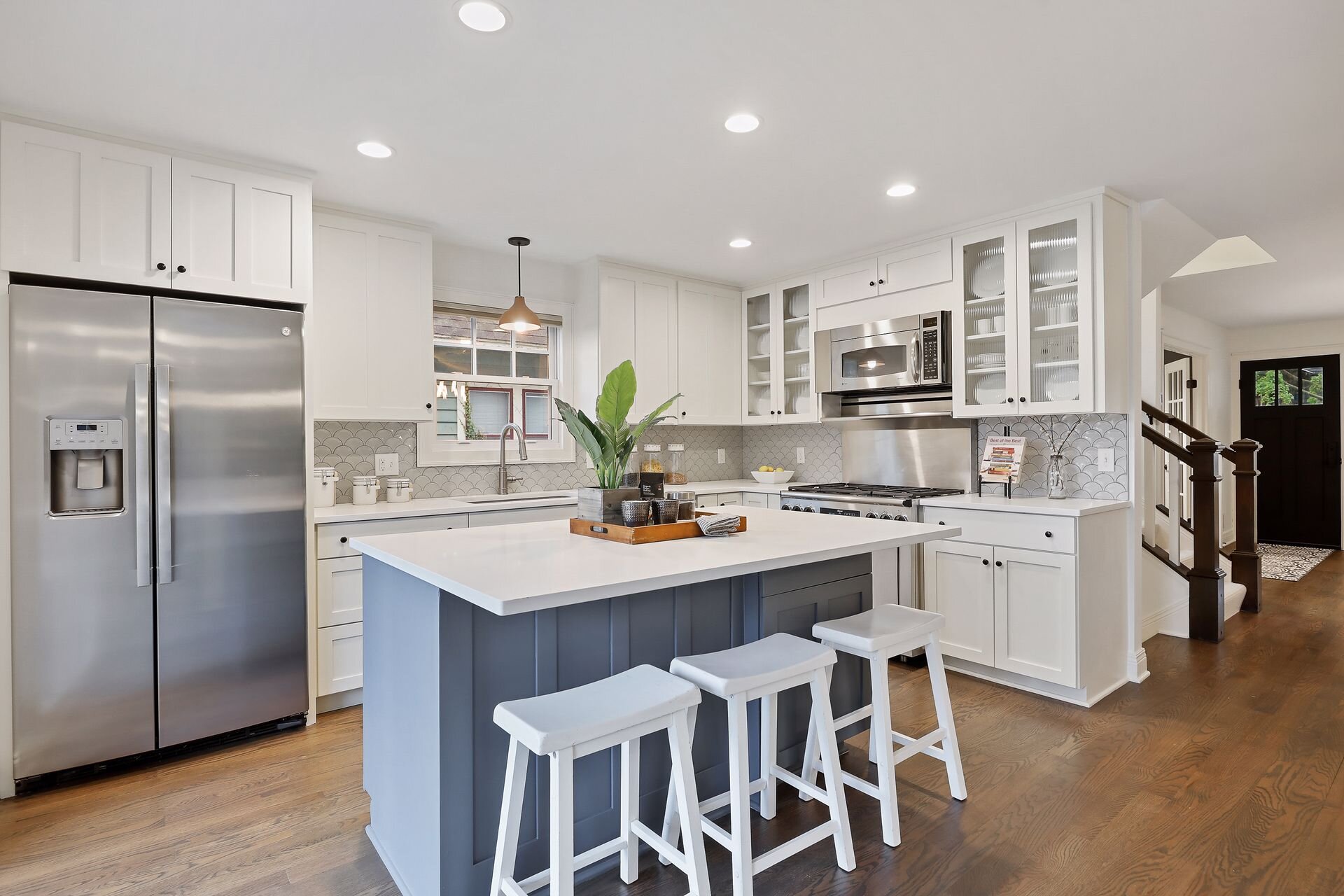 12 Kitchen revovation completed in 2018. Owners chose a larger island with seating, upgraded refrigerator and dishwasher and installed a new tile backsplash.jpg