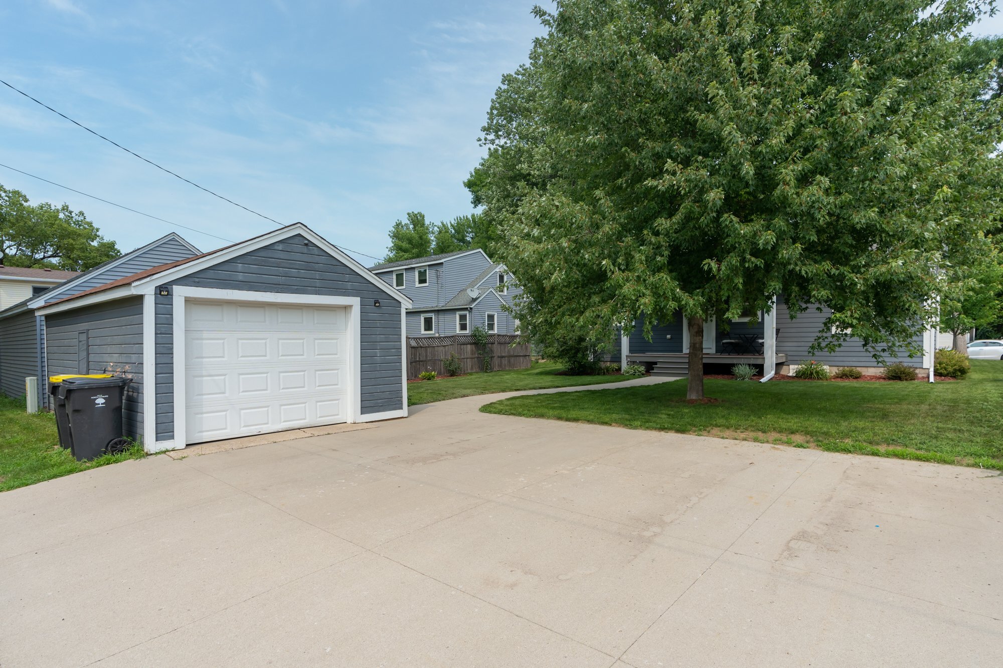 30.  Original one car garage with new concrete driveway, enough space to park three additional vehicles.jpg