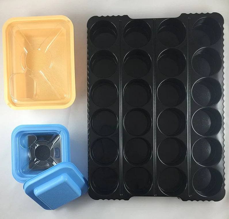 Image of clean thermoforming products in various colors and materials.