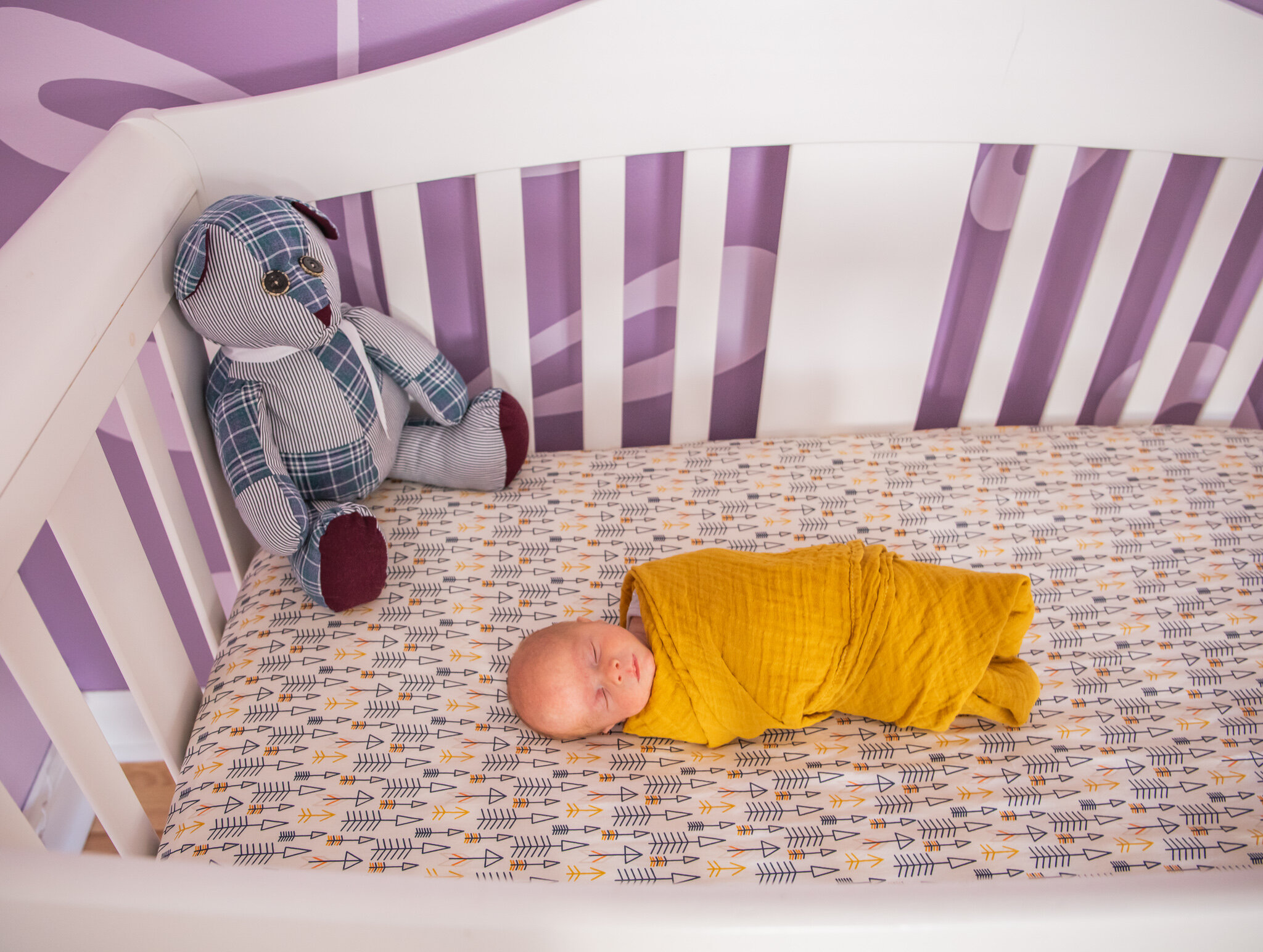 Newborn session, baby asleep in a crib