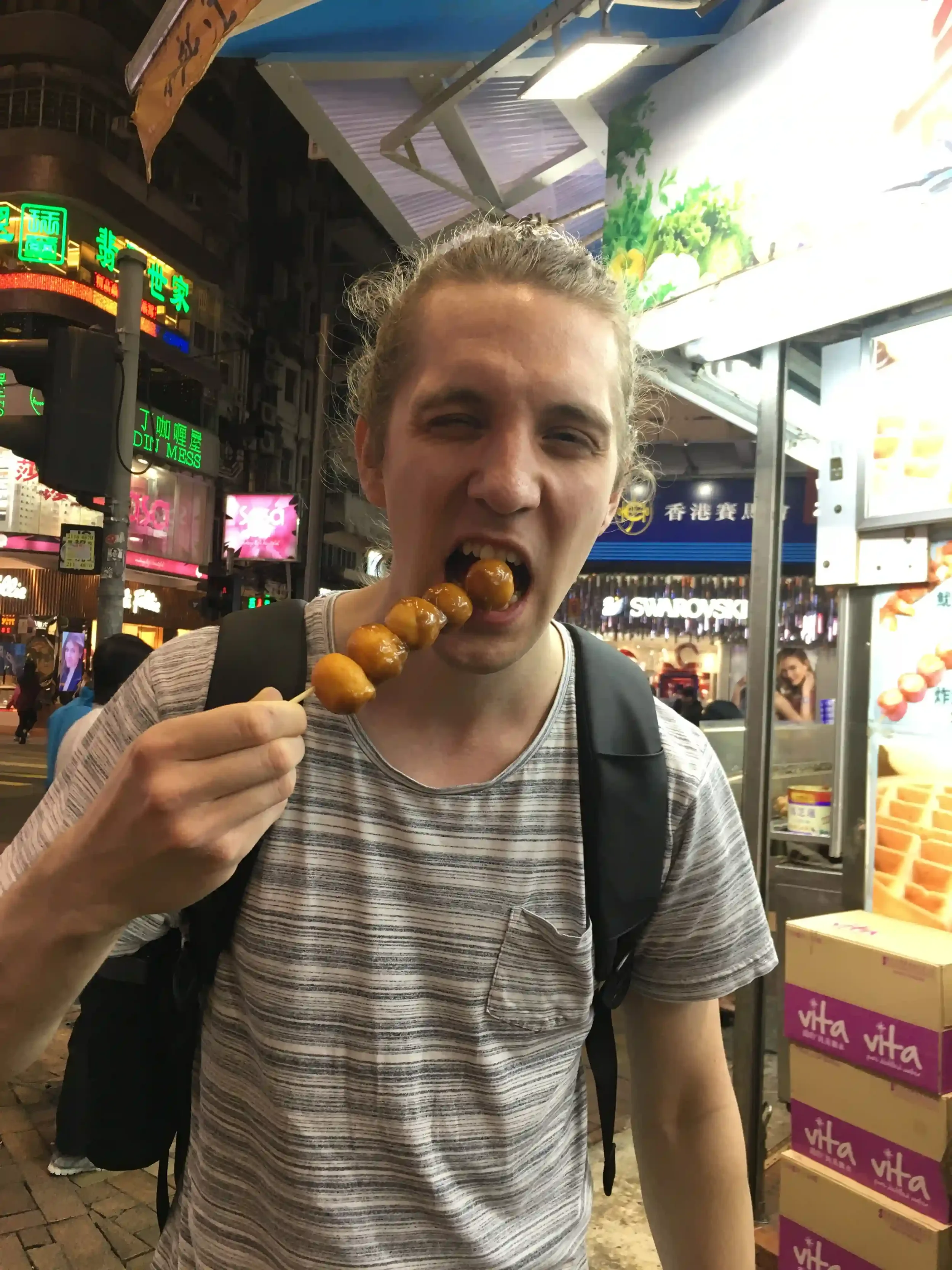 Christian Tapper eating curry fish balls from a street stall in Hong Kong in 2017, where he decided to learn Cantonese.