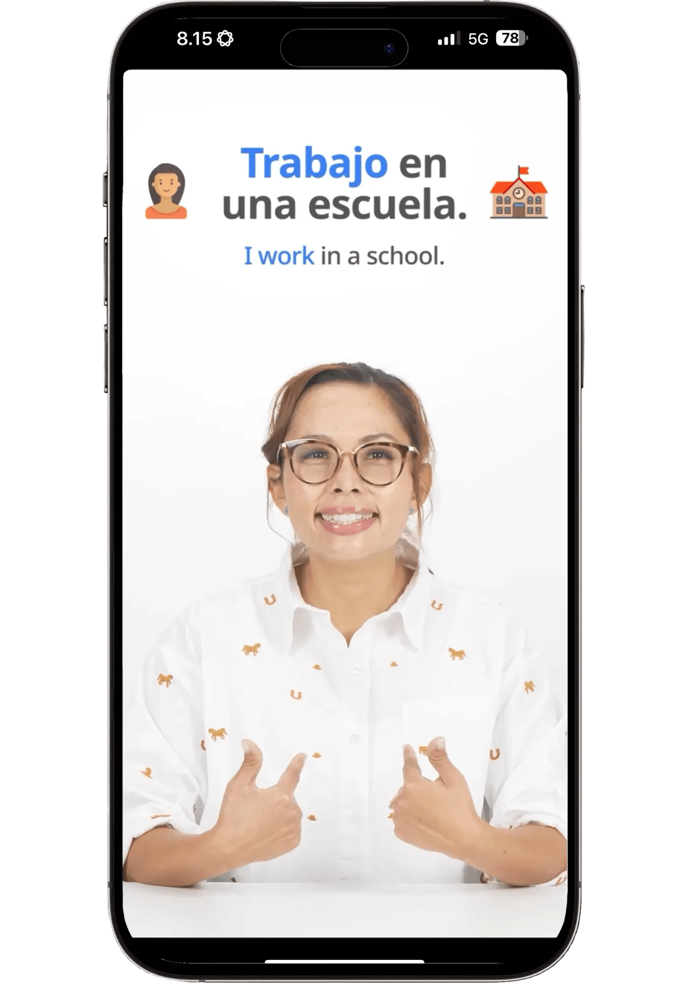 A Speak Spanish video lesson featuring a real human teacher demonstrating the phrase "Trabajo en una escuela."