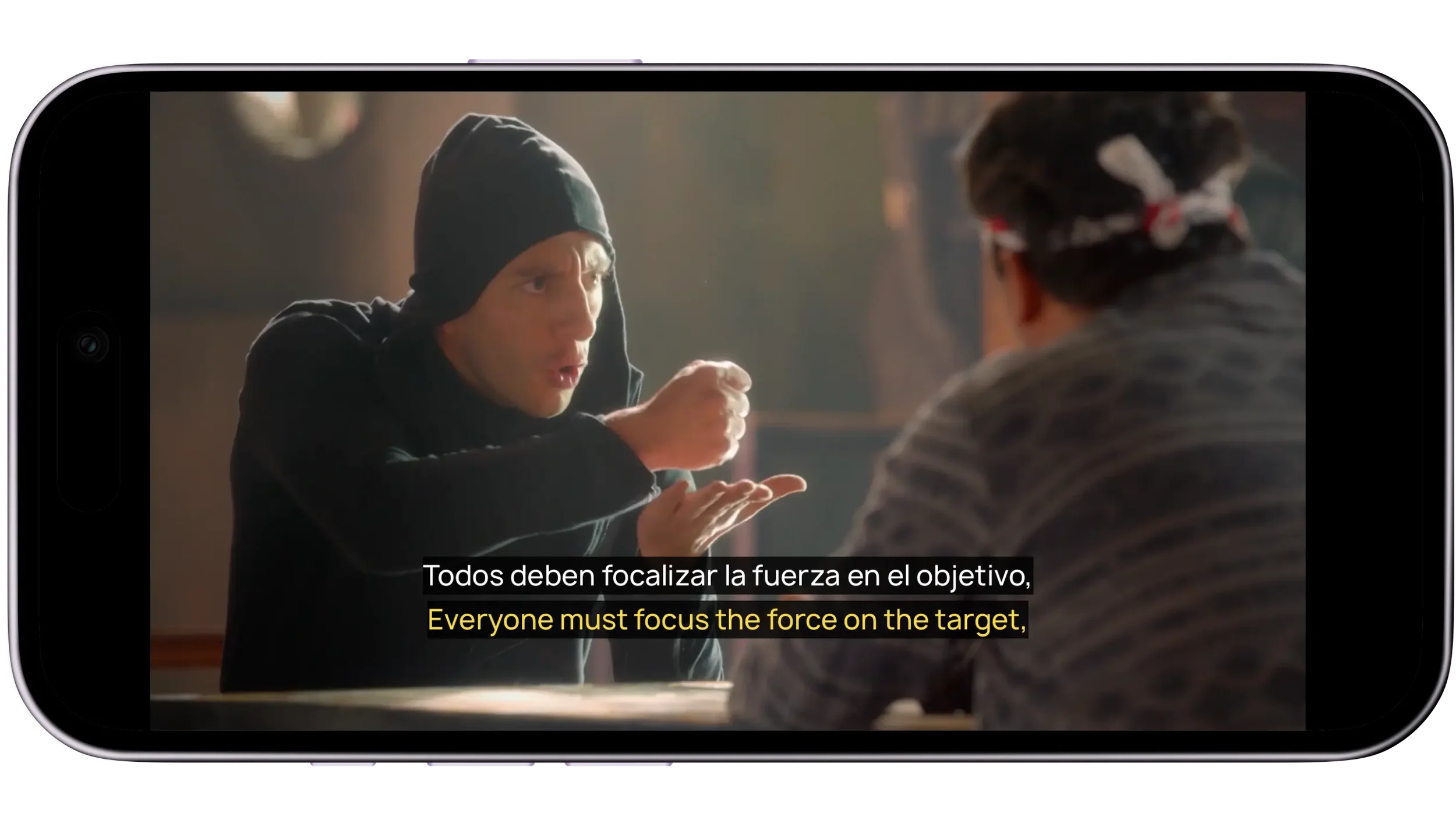Lingopie's mobile app showing dual Spanish and English subtitles overlaid on a TV show, with the Spanish subtitle in white above the English translation in yellow.