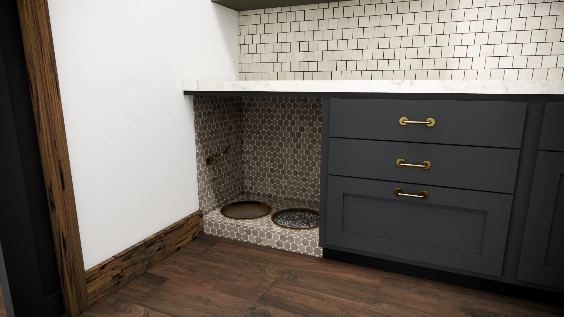 Interior of a modern bathroom vanity area with a dark gray cabinet featuring three gold handles, a white marble countertop, a brick wall, and a small tiled alcove with gold fixtures for a sink.