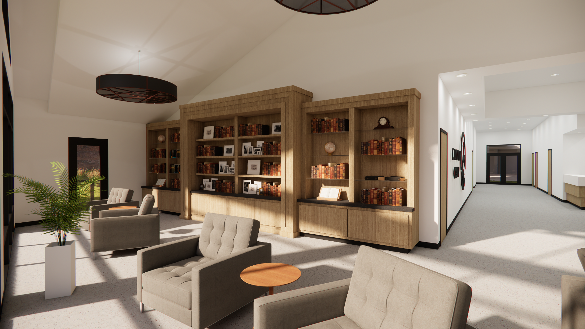 Interior of a living room with built-in wooden bookshelves filled with books, framed photos, and decorative objects. There are beige armchairs, a potted plant, and large windows letting in natural light. The room has a modern design with light-colore