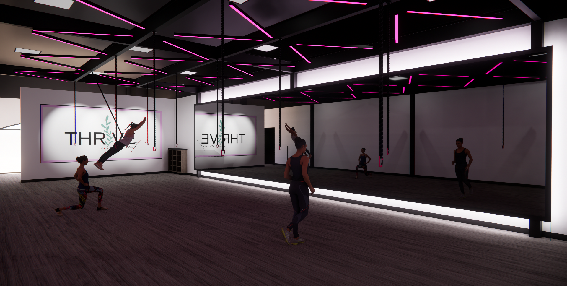 Indoor fitness studio with people exercising, including a woman swinging on gymnastic rings and others standing or kneeling on the floor. Neon pink lights decorate the black ceiling, and a large mirror reflects the scene. A wall has company branding 