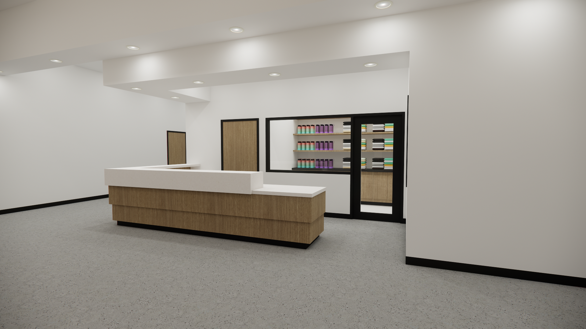 A modern, minimalistic reception area with a white L-shaped counter, wooden base, and black trim. Behind the counter is a glass-enclosed display of shelves filled with colorful items, possibly books or supplies. The walls are white, with two wooden d