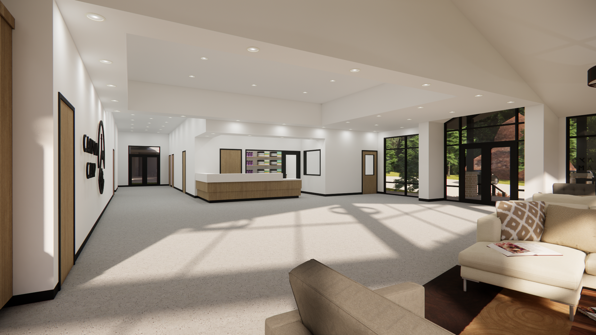Interior of a modern lobby with white walls, large windows, a reception desk, and comfortable seating.
