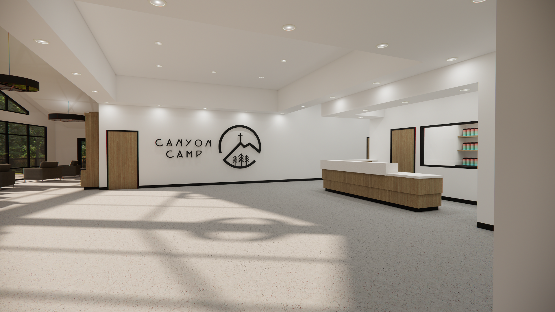Modern lobby reception area with white walls, a branded sign reading 'Canyon Camp' and a logo of a mountain with trees and a cross, a wooden front desk, and seating area with chairs and large windows showing greenery outside.
