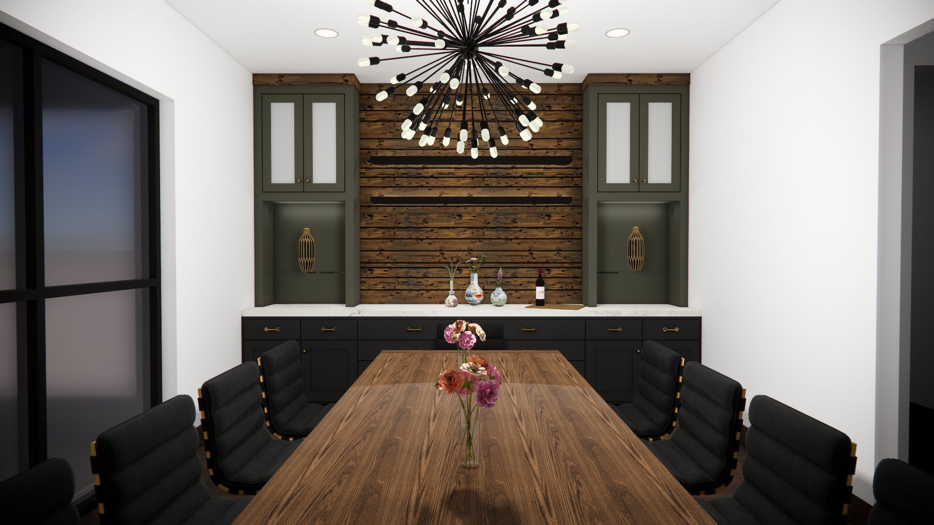 A modern dining room with a large wooden table, black chairs, and a decorative wooden accent wall with a built-in cabinet, vases, flowers, and a wine bottle. A black and gold chandelier hangs from the ceiling.