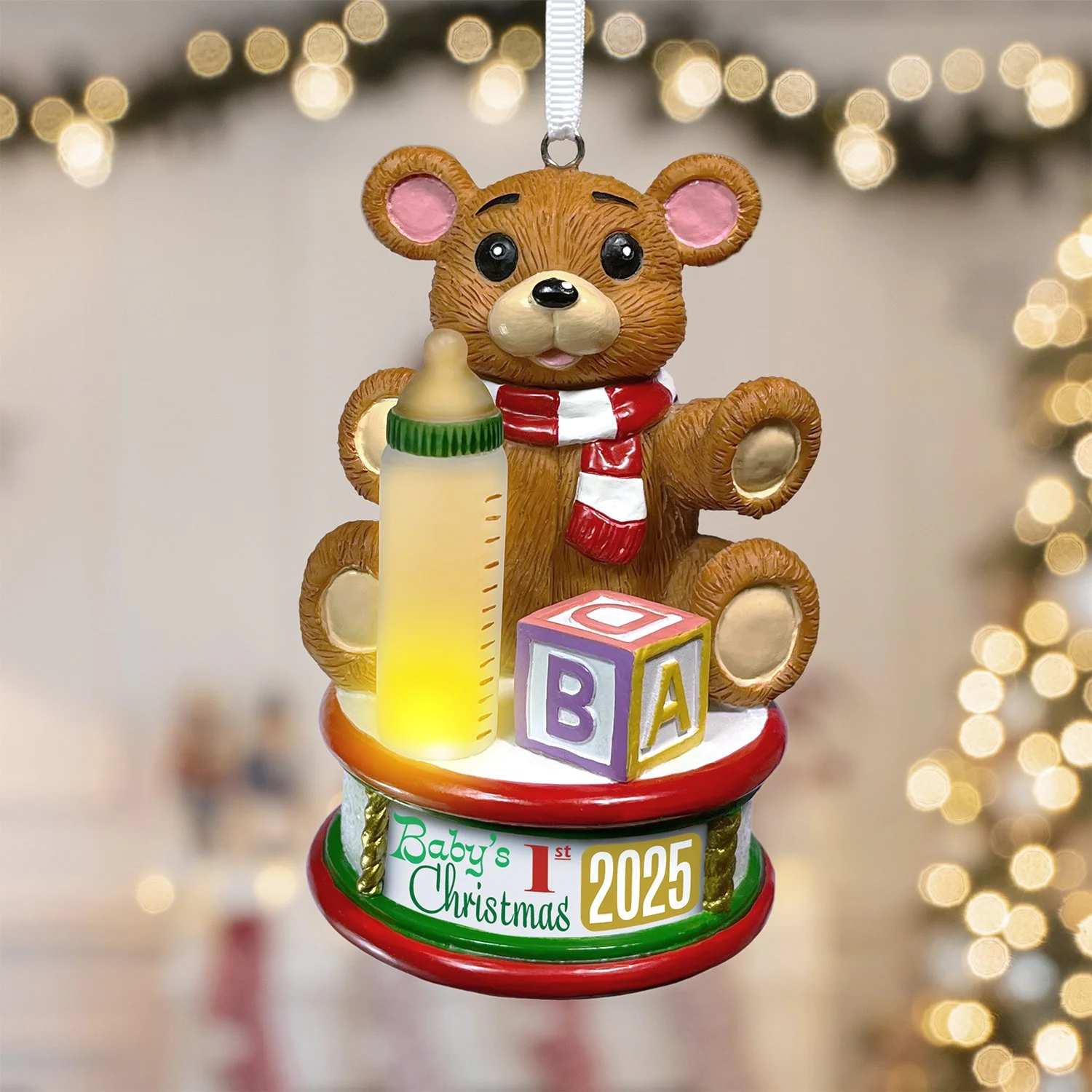 Hand-painted teddy bear ornament on festive drum for baby's first holiday