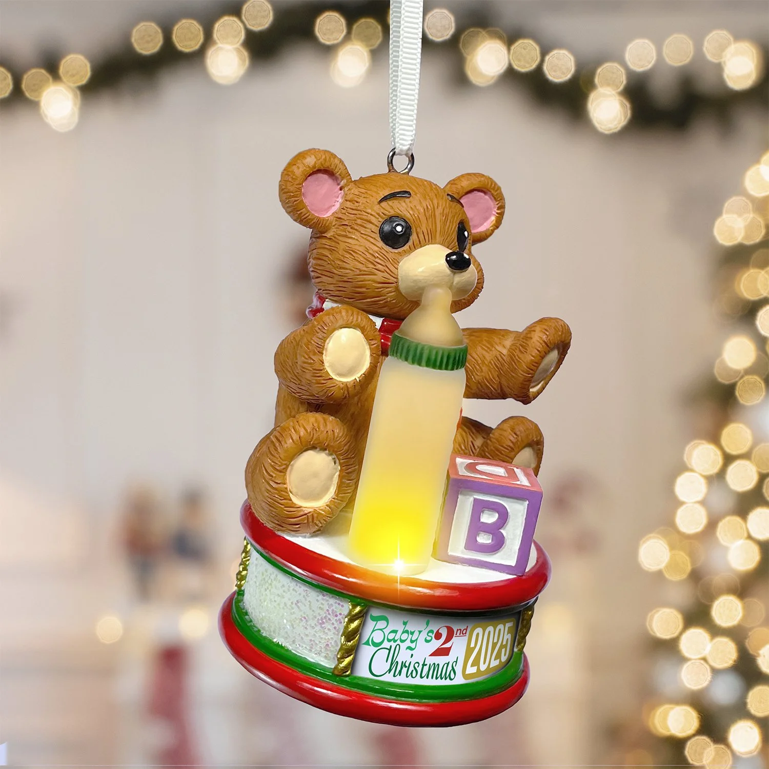 Resin baby ornament with glowing details and vibrant holiday colors ready to hang