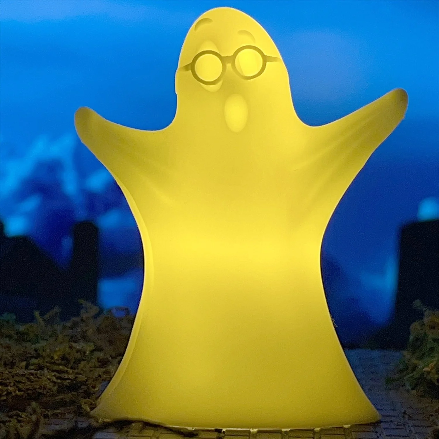 3D printed Nerdo Ghost Halloween decoration glowing with LED light on mantel