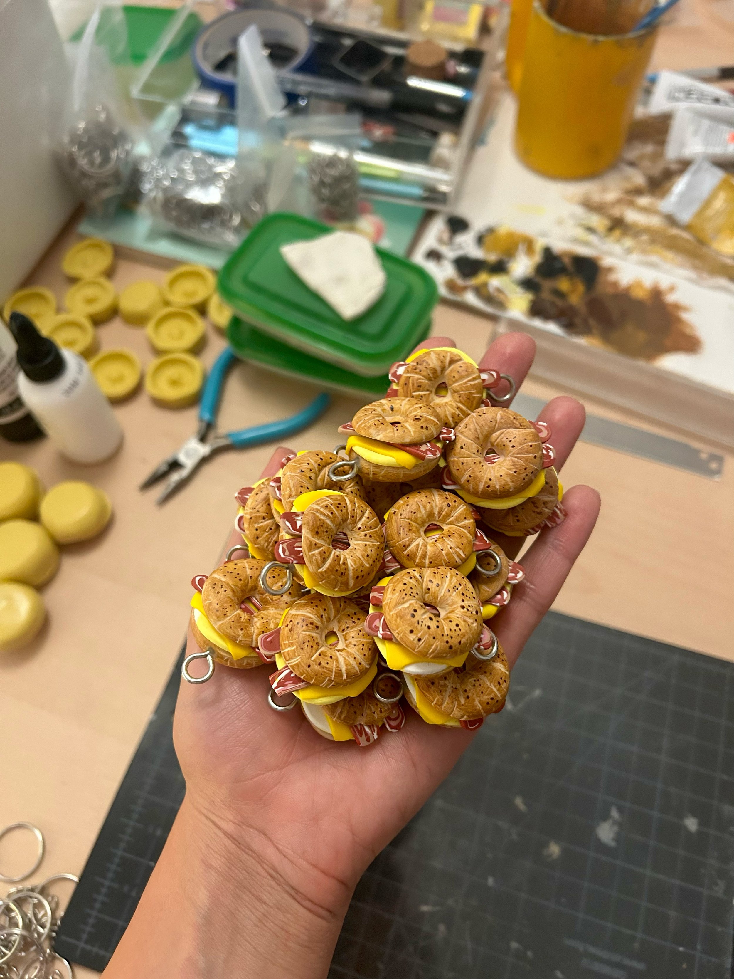 Making of the miniatures bagels. Materials used were acrylic paint, polymer clay, and stainless steel.