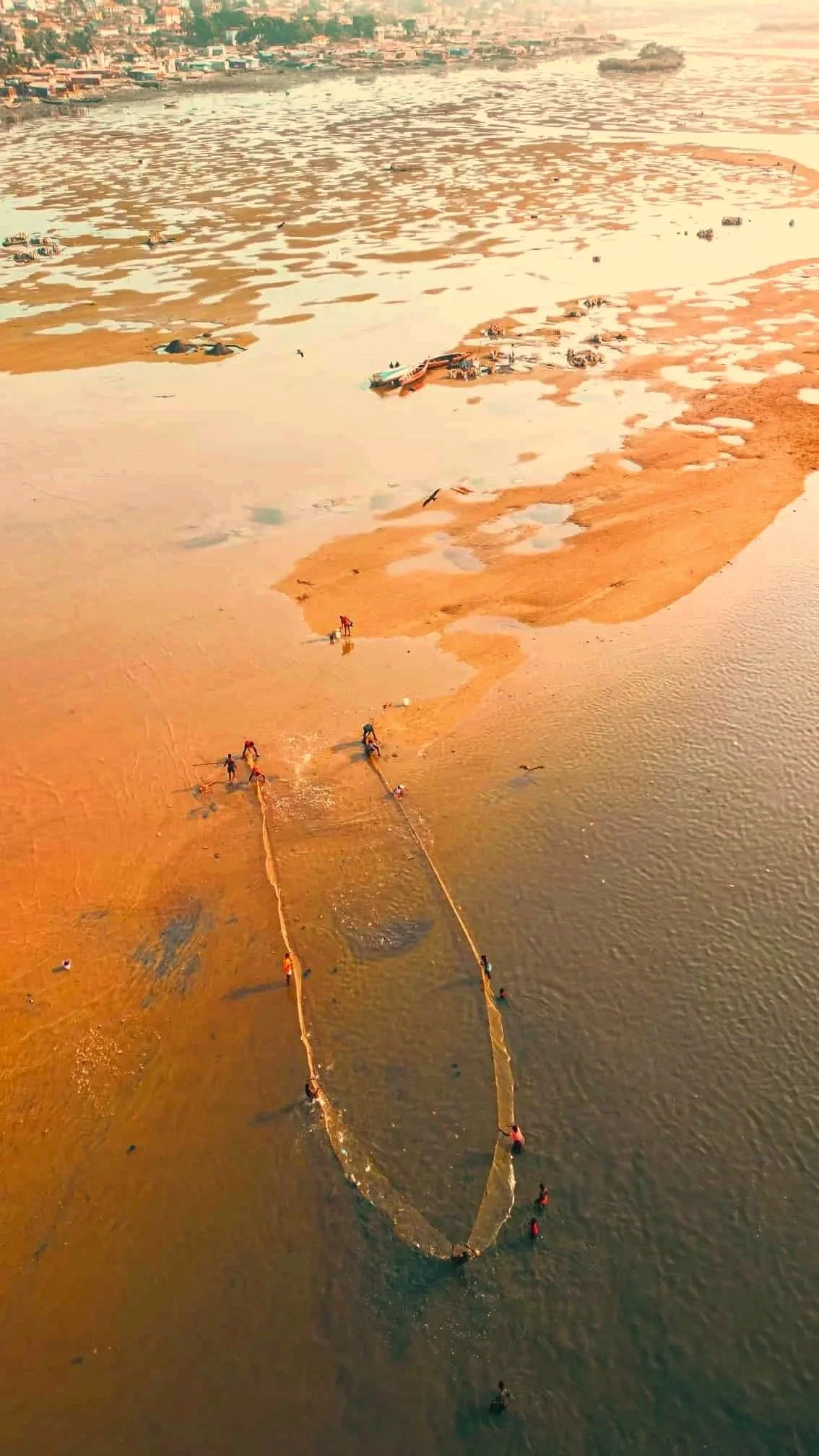 Fishermen casting nets at Aberdeen Creek