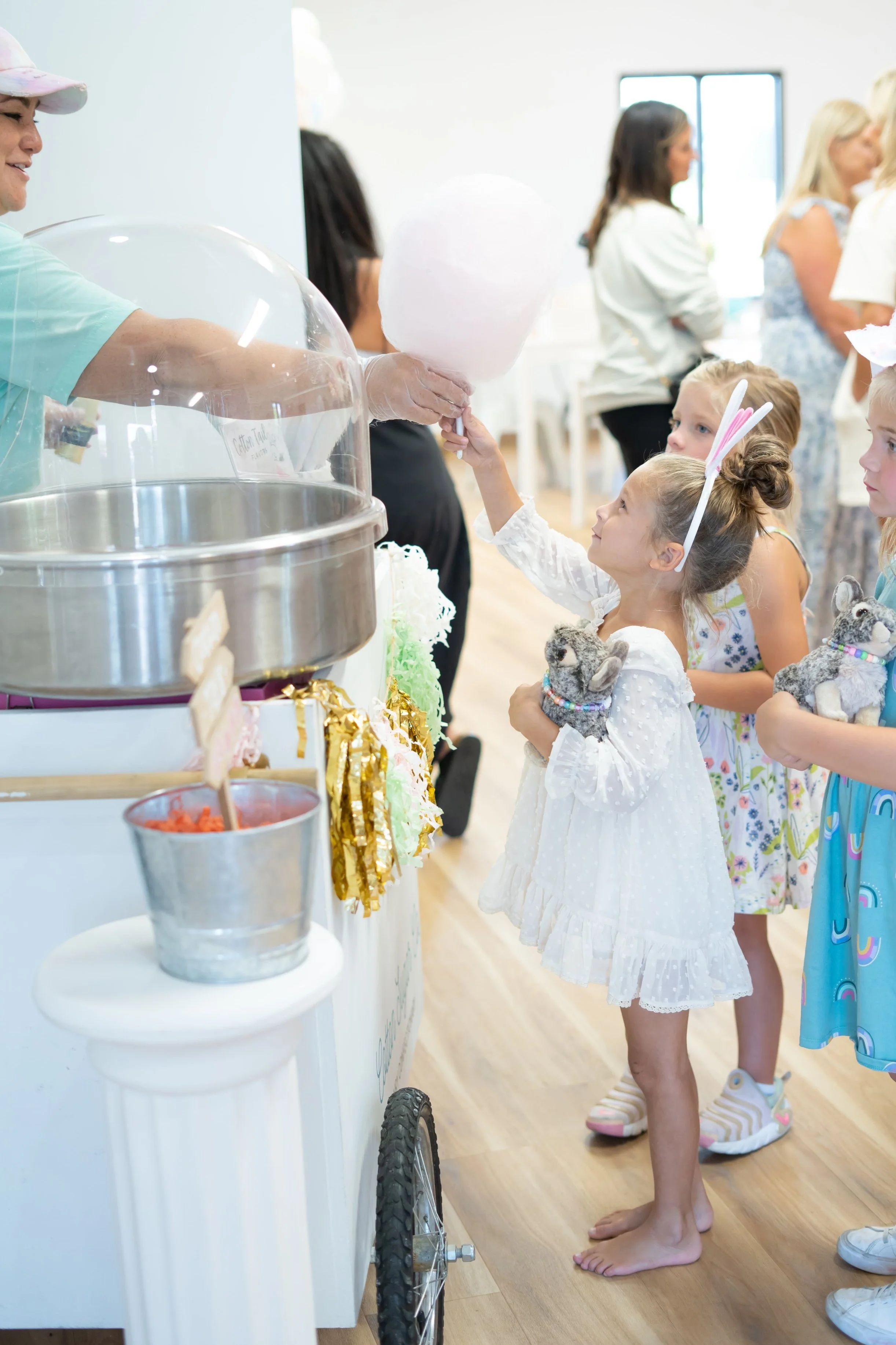 Girl getting cotton candy at Easter celebration
