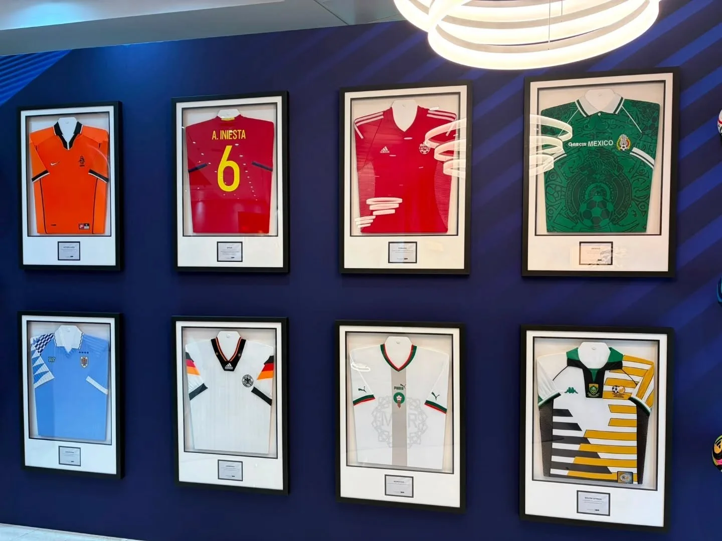 A project we worked on a few months ago with multiple World cup shirts from bygone eras. 

This picture was shared with us today. Our client, a major Sponsor of the upcoming World Cup tournament, showcasing our framing at their London offices.

The f