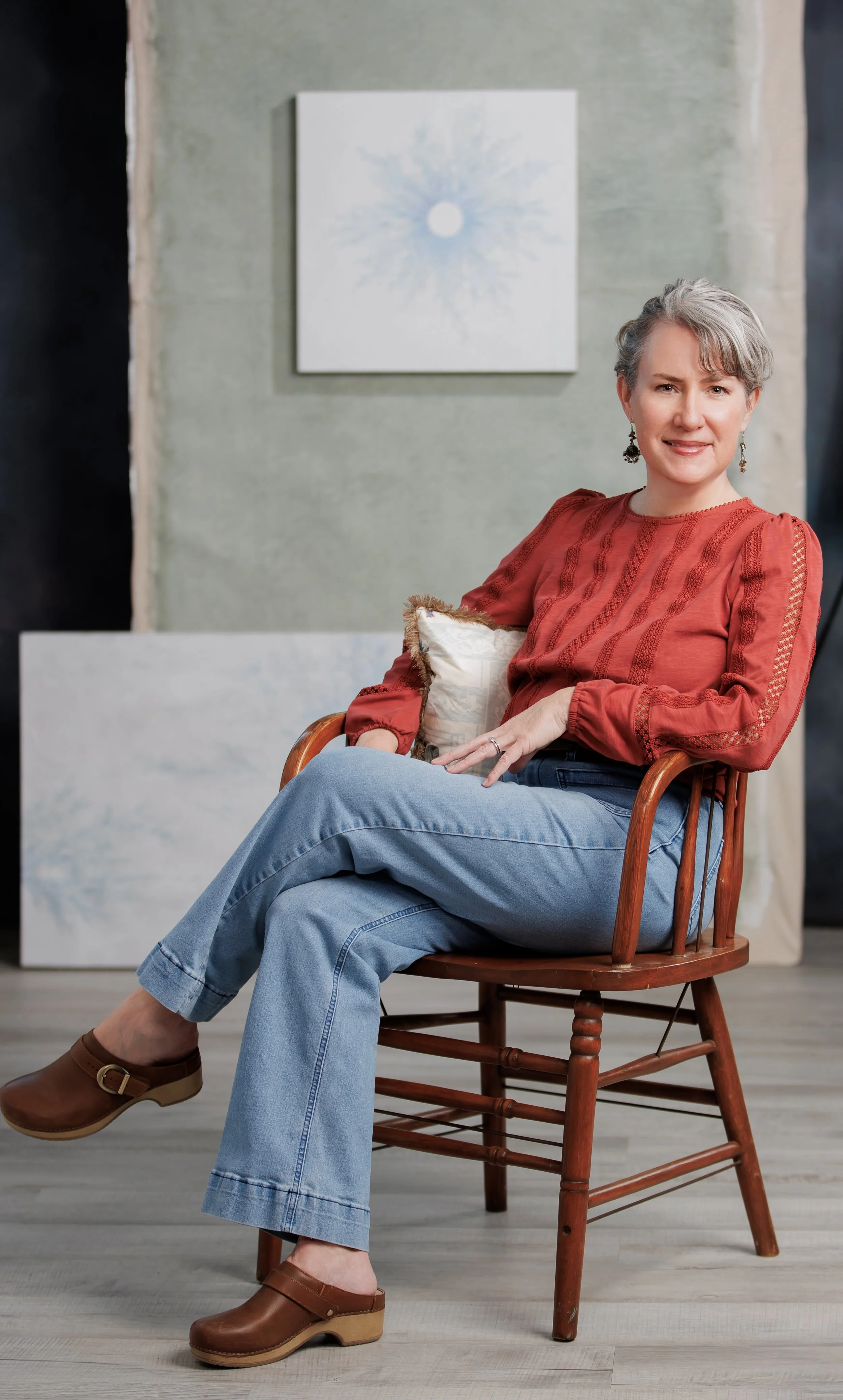 Artist Erin Daniels sitting in her art studio