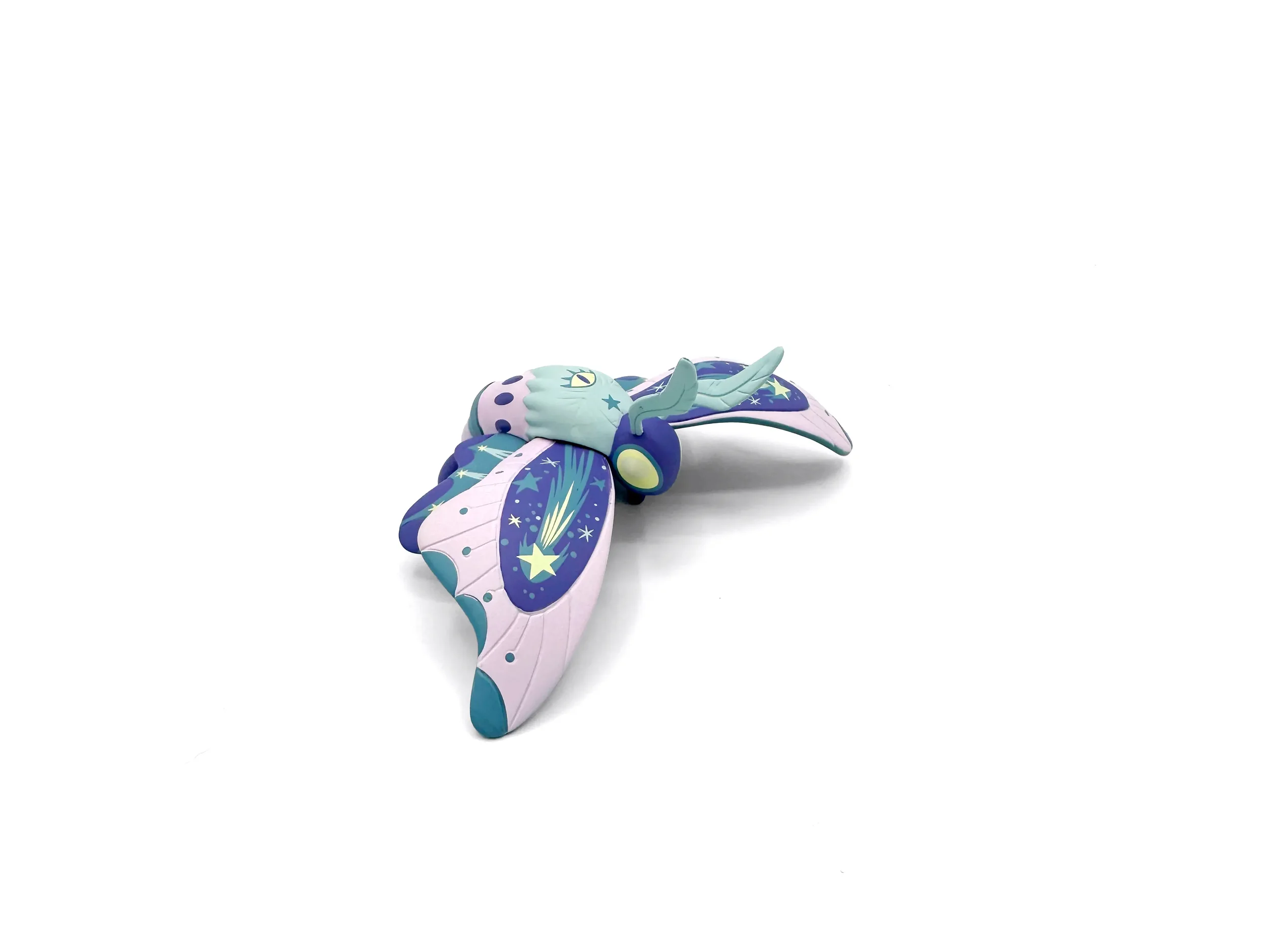 Stephanie Buscema Astroptera Stelle vinyl moth art toy, three-quarter side view showing comet and star wing details