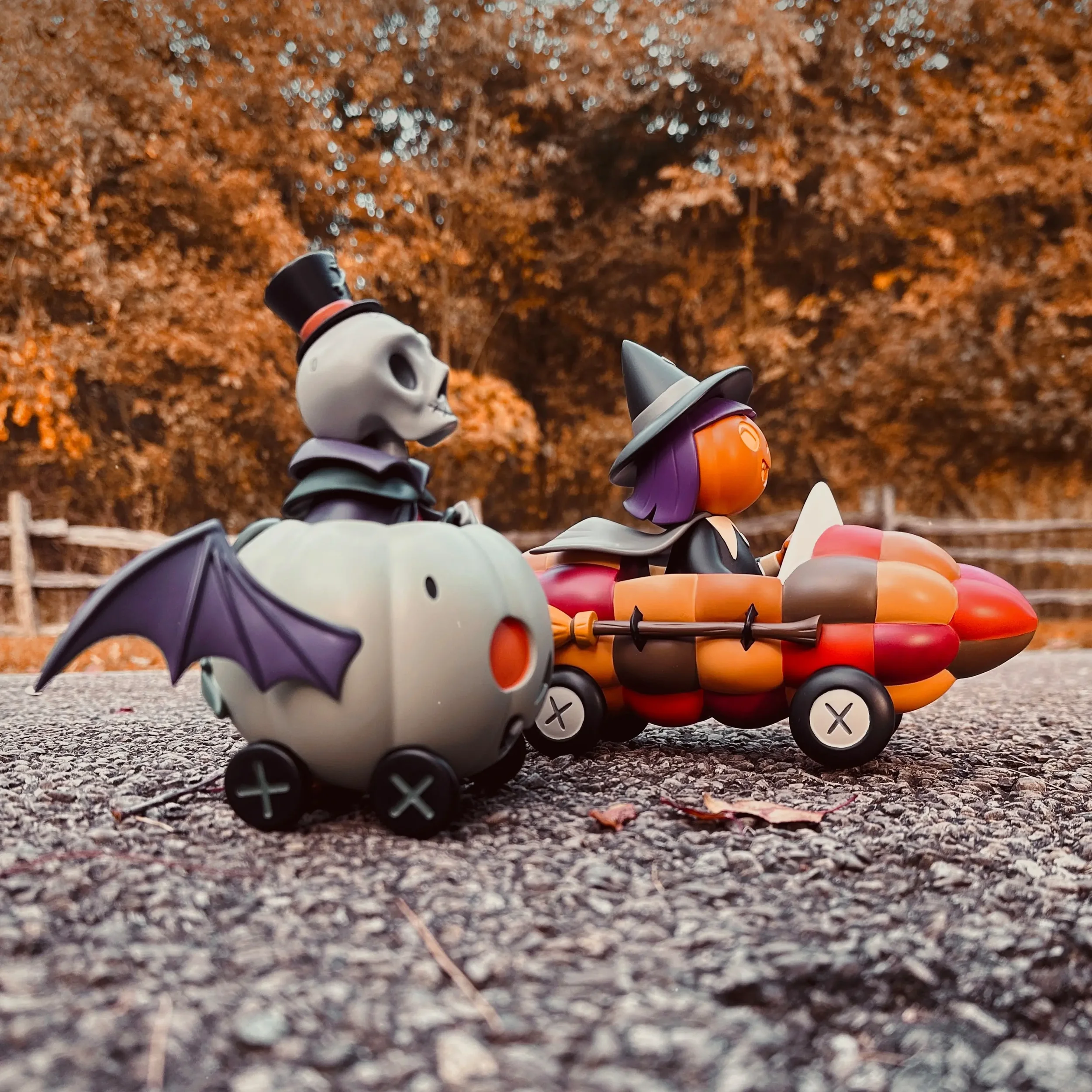 Stephanie Buscema Corny Cruisers resin art toys, side view of Nigel's Ghostly Gourd Racer and Willa's Corn Cob Cruiser