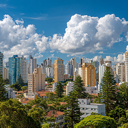 skyline of curitiba with blue skies and white puffy clouds