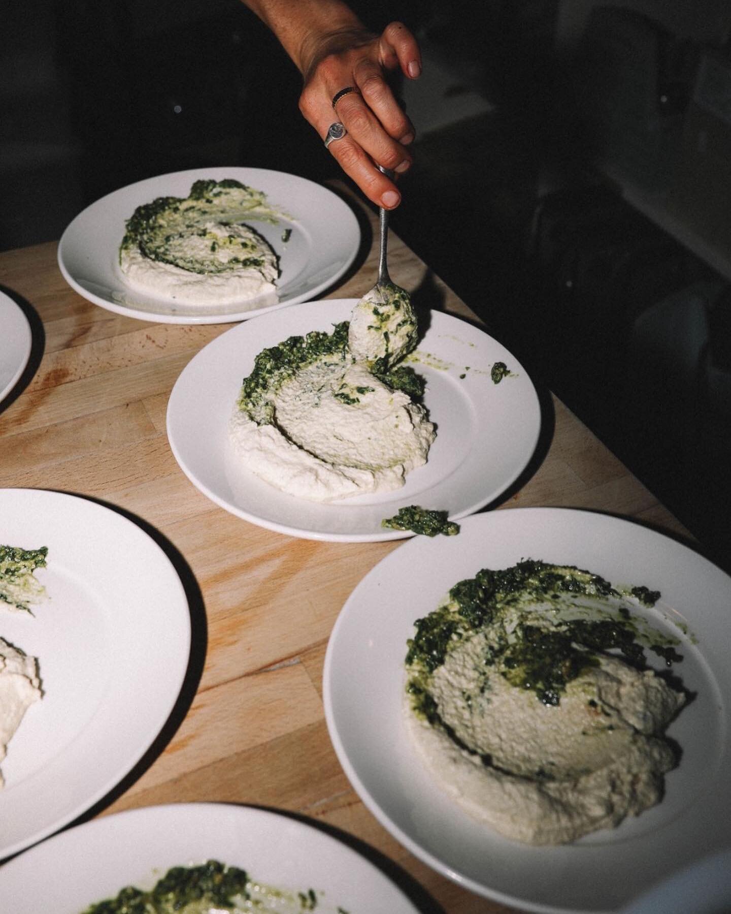 The base of a double cooked potato dish. Cashew aioli and kale pesto, before being topped with the potatoes, nut parmesan and micro herbs. 📷 @abbieroden of @drinkamie