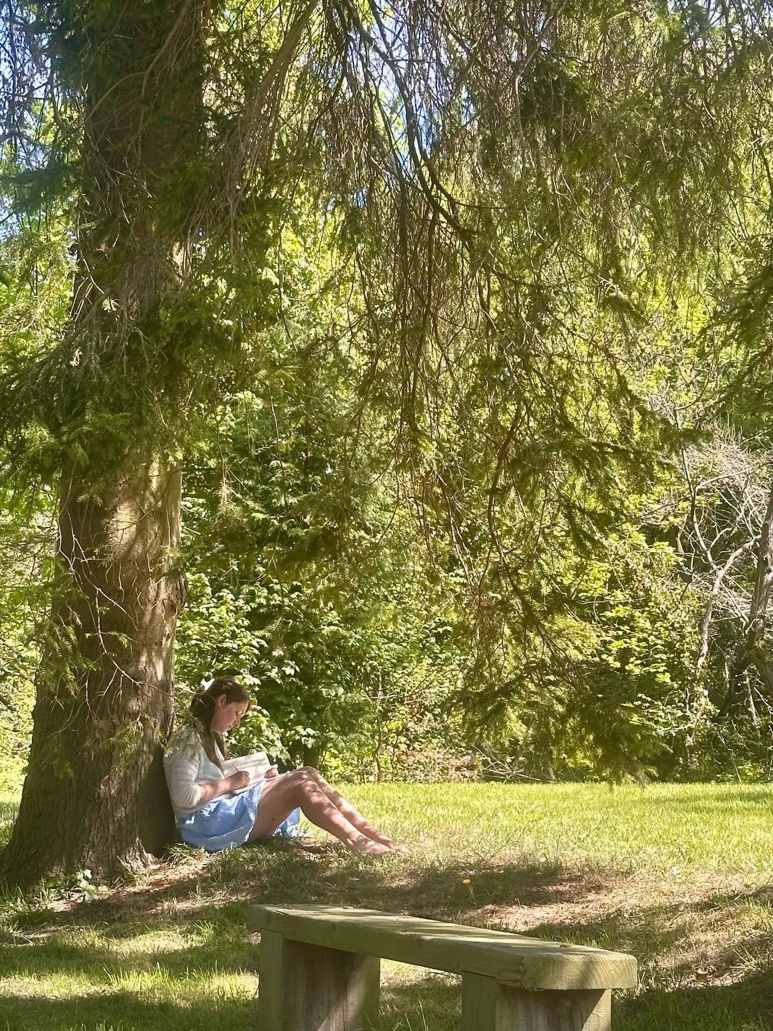 Katie Newman sat under a tree journaling
