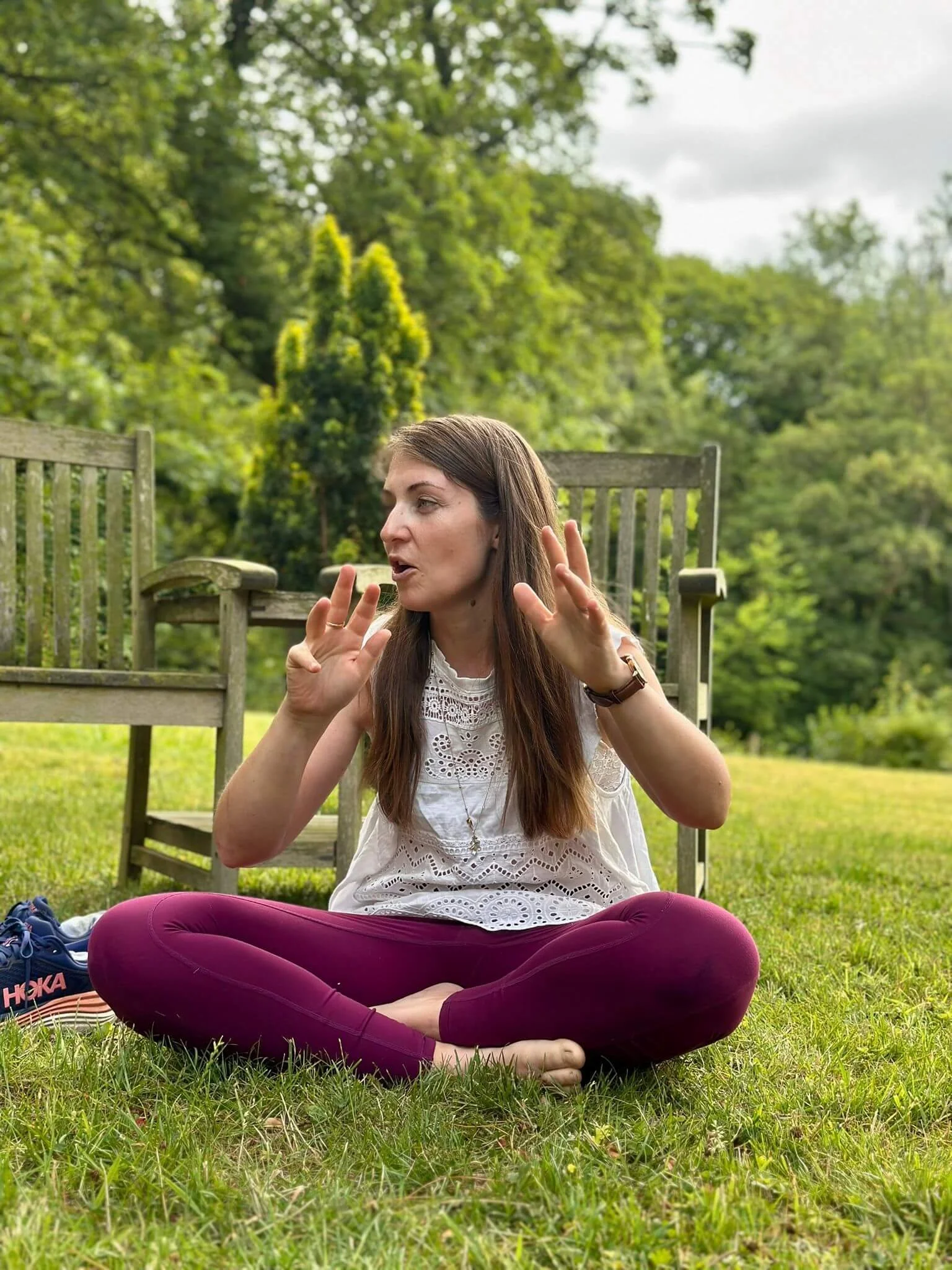 Katie Newman sat crossed legged with hand in the air talking
