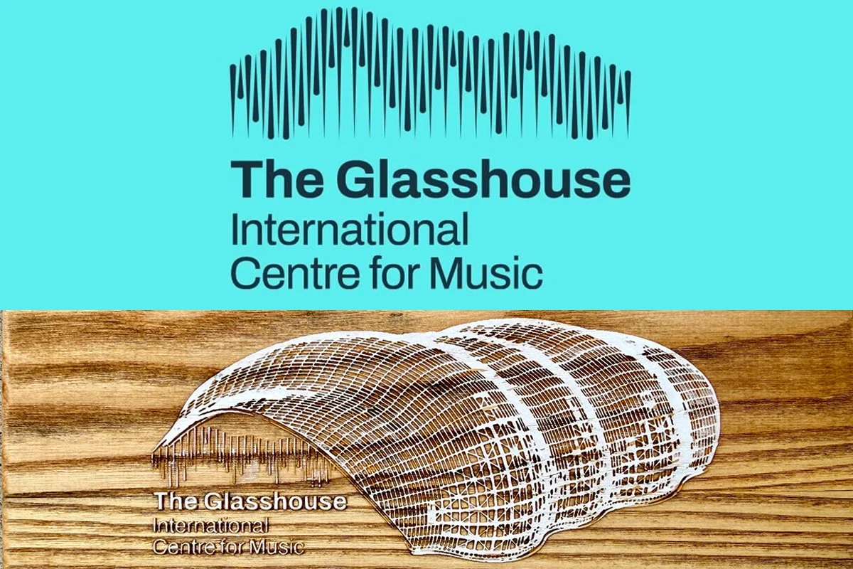 Logo for The Glasshouse International Centre for Music, featuring a stylized building design in white on a wooden background, with text in black above it.