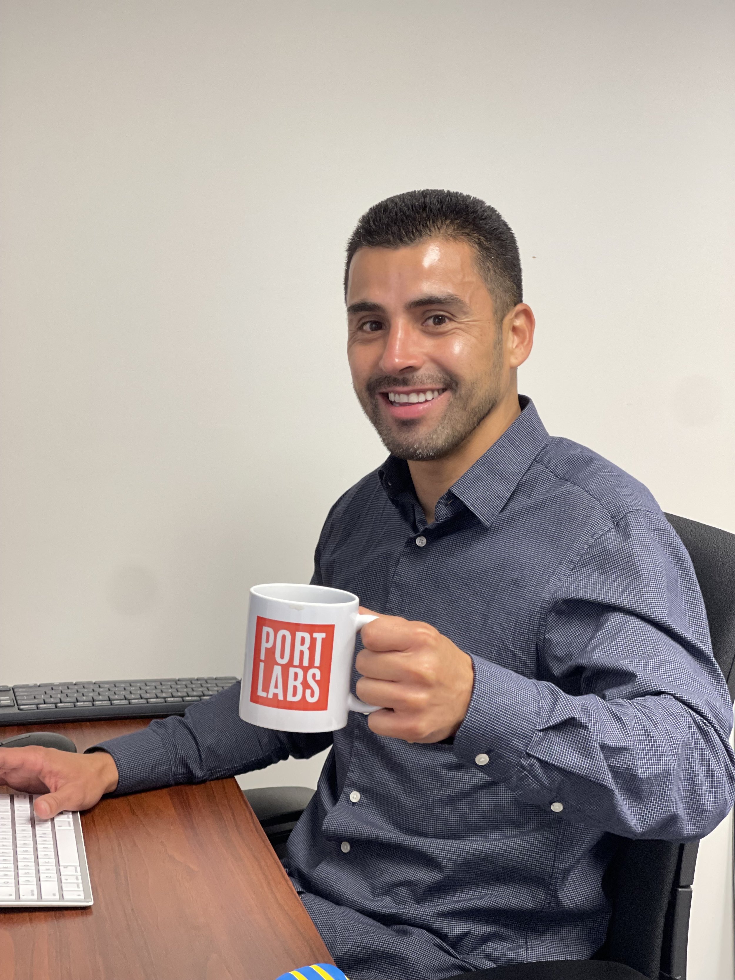  Hector Ramos from ICA's investment team enjoying his new office, and his fancy new mug! 