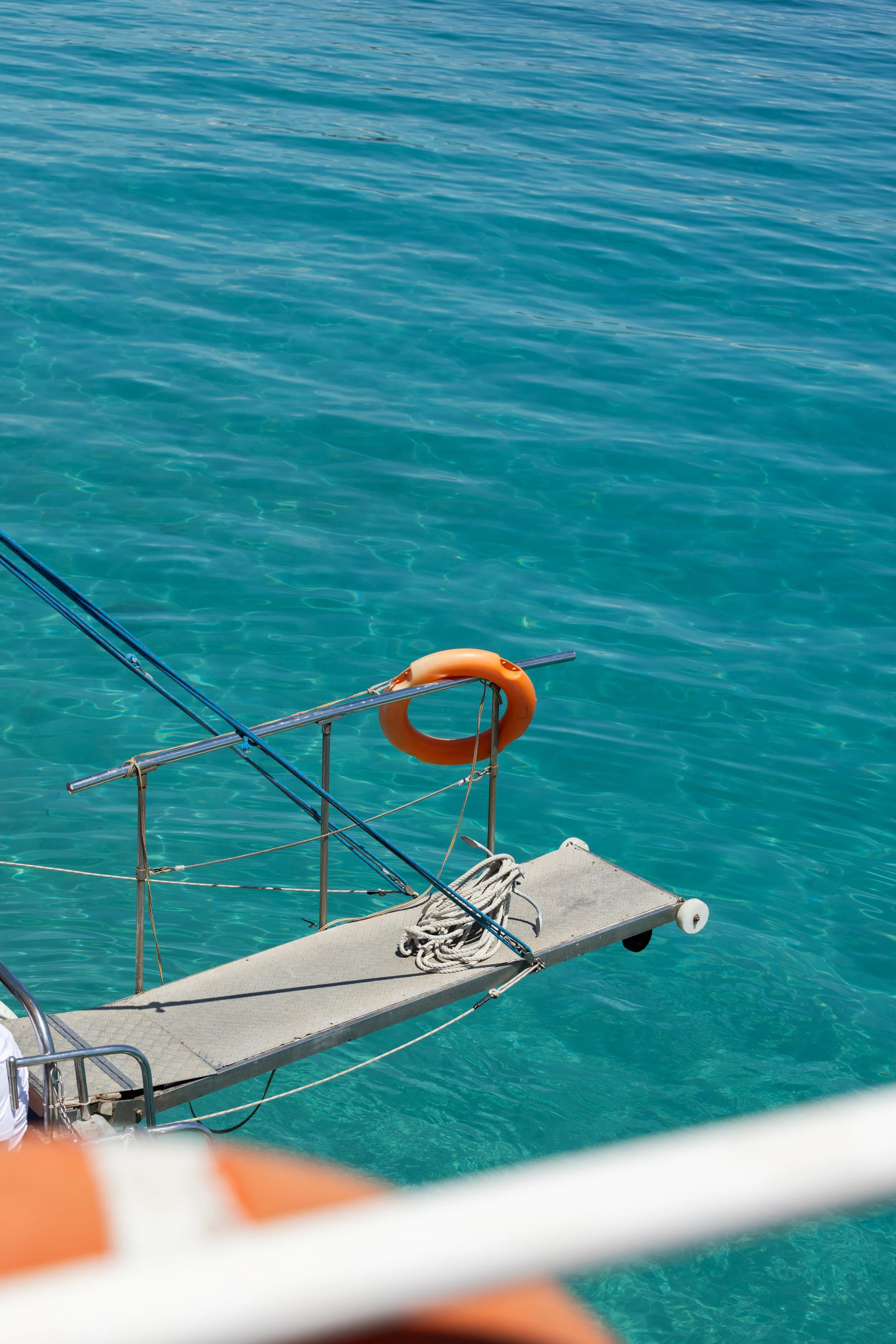 A photo of a diving board over blue sea on a boat
