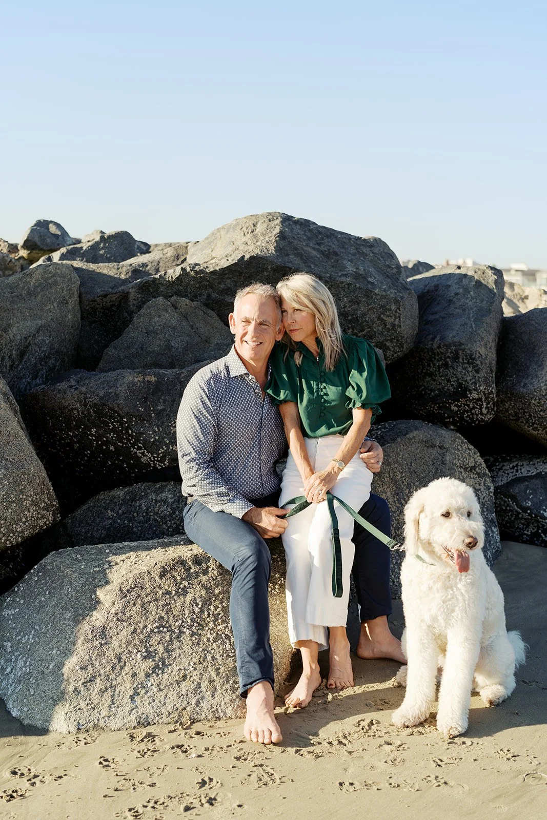 Couple with their dog during a coastal family photography session in Newport Beach, California.