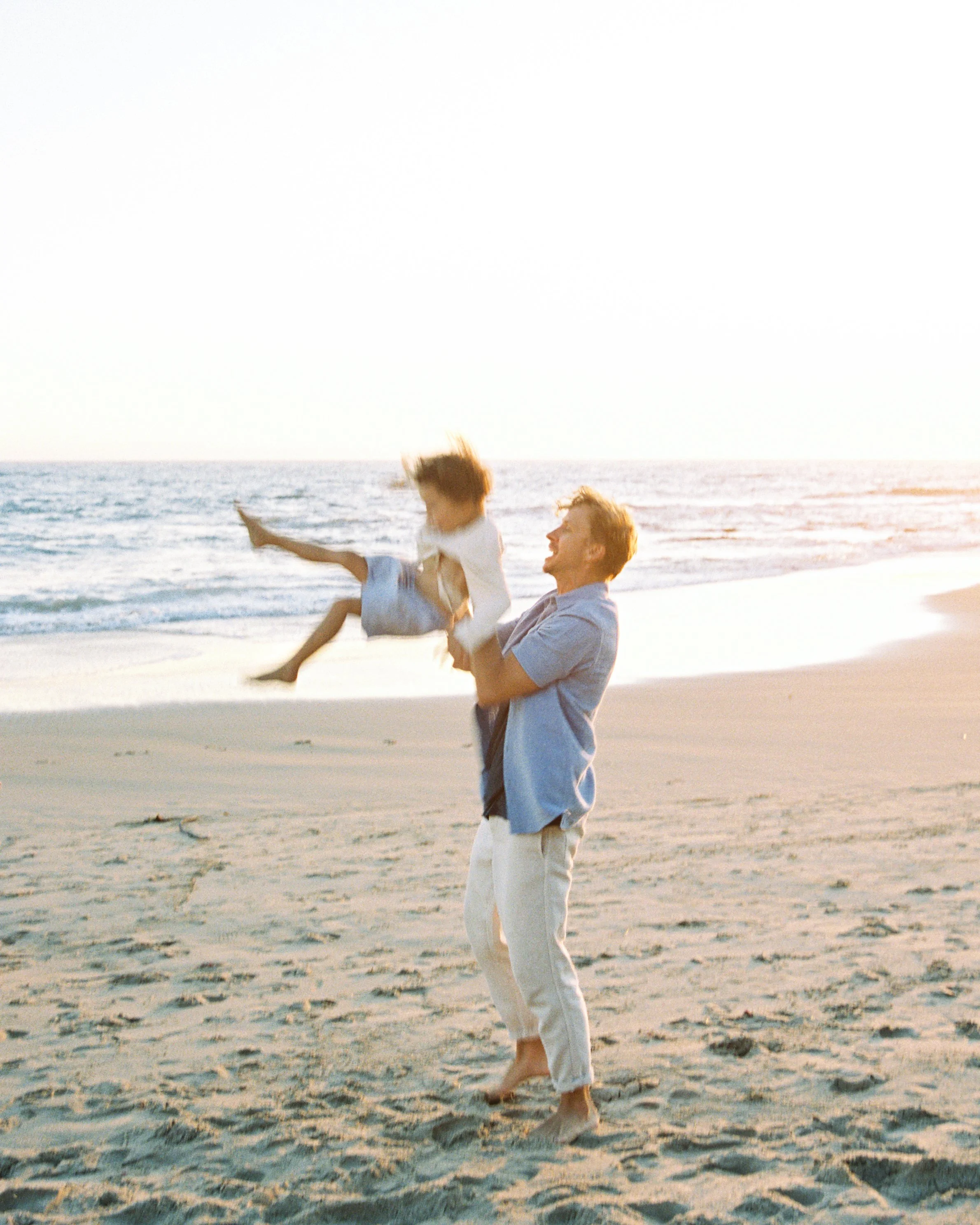 Joyful family moment captured during a coastal family photography session in Southern California.