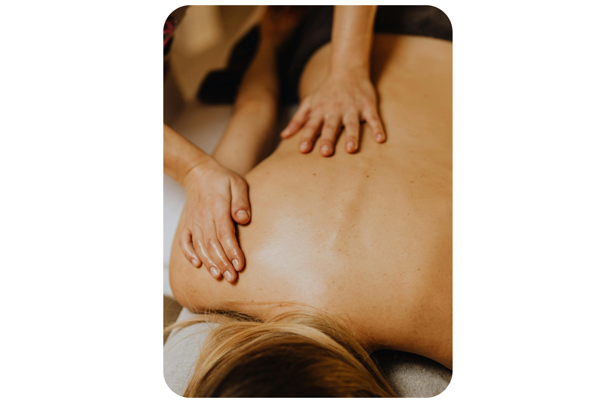 A person receiving a back massage from another person, with hands pressing on their back.